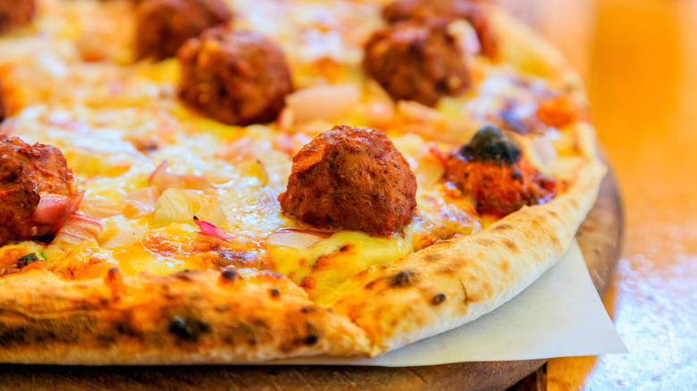 1. Cook them in grape jelly for a sweet and savory snack, 2. Stuff frozen meatballs into a sandwich, 3. Use frozen meatballs as taco filling, 4. Combine them with pineapple and peppers for a sweet and sour dish, 5. Serve frozen meatballs with gravy on top of mashed potatoes, 6. Pile them onto a pizza, 7. Add frozen meatballs to veggie soup to bulk up the dish, 8. Air fry meatballs for a crispy bite, 9. Make bite-sized sliders for your next party, 10. Bake frozen meatballs into a casserole for a hearty dinner, 11. Stuff the meatballs in pasta shells, 12. Cook them in a curry sauce to maximize flavor, 13. Add them to French onion soup