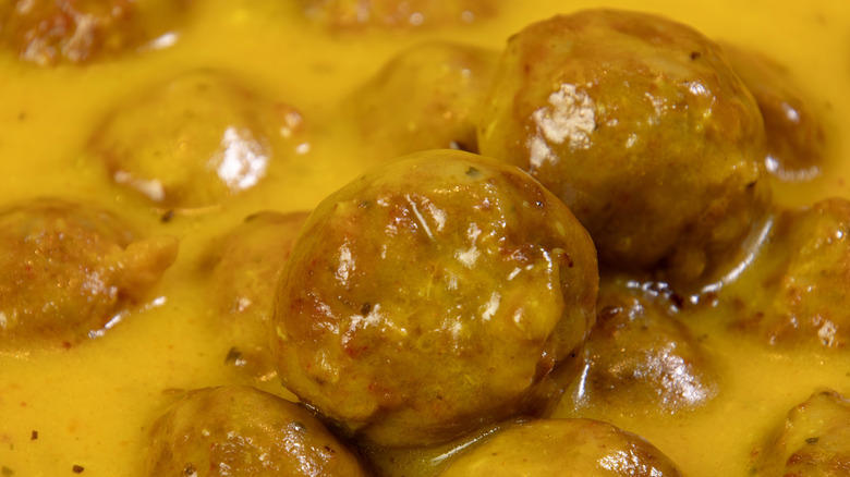 1. Cook them in grape jelly for a sweet and savory snack, 2. Stuff frozen meatballs into a sandwich, 3. Use frozen meatballs as taco filling, 4. Combine them with pineapple and peppers for a sweet and sour dish, 5. Serve frozen meatballs with gravy on top of mashed potatoes, 6. Pile them onto a pizza, 7. Add frozen meatballs to veggie soup to bulk up the dish, 8. Air fry meatballs for a crispy bite, 9. Make bite-sized sliders for your next party, 10. Bake frozen meatballs into a casserole for a hearty dinner, 11. Stuff the meatballs in pasta shells, 12. Cook them in a curry sauce to maximize flavor, 13. Add them to French onion soup