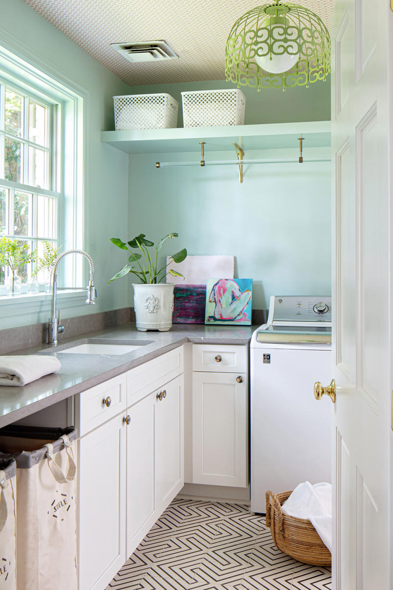 Embrace a color-drenching moment, Say yes to spray paint, Just add curtains, Nod to location, Work your vertical space, Don’t overlook the floor, Use a sliding door, Don’t hold back on detail, Add a clothing rod, Create a multiuse space, Add color with a bold wallpaper, Plan around storage, Don’t forget the art, Install high shelving, Put every flat surface to use, Incorporate hampers for easy organization, Put a drying rack on the wall, It’s okay to cover windows, Keep laundry materials out of sight, Create a dual mudroom, Built-in furniture is not the only path to success, Place pattern all over, Install a unique light fixture, Place cabinets on top of your washer/dryer, Add texture with cabinet fronts, Hide away your washer and dryer, Camouflage appliances, Go for sliding racks, Lean into neutrals, Add a countertop to a galley laundry room, Choose a vibrant color scheme, Play with geometry, Opt for moody elegance