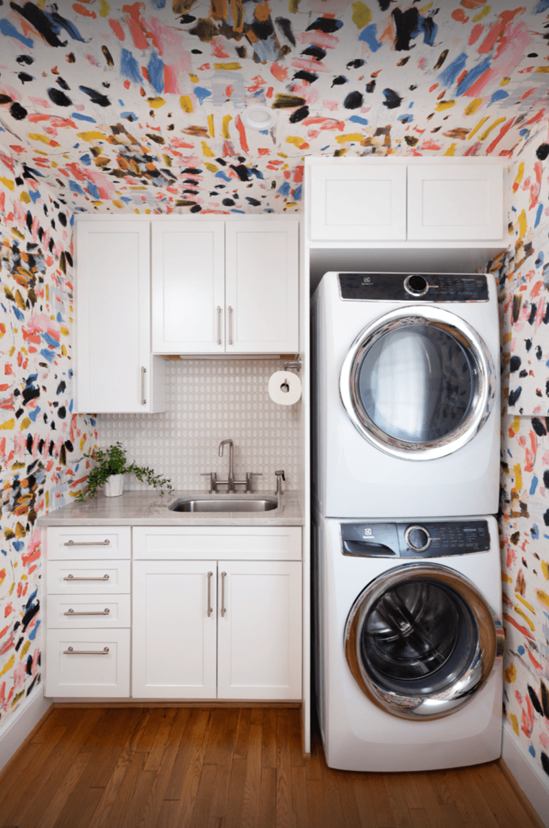 Embrace a color-drenching moment, Say yes to spray paint, Just add curtains, Nod to location, Work your vertical space, Don’t overlook the floor, Use a sliding door, Don’t hold back on detail, Add a clothing rod, Create a multiuse space, Add color with a bold wallpaper, Plan around storage, Don’t forget the art, Install high shelving, Put every flat surface to use, Incorporate hampers for easy organization, Put a drying rack on the wall, It’s okay to cover windows, Keep laundry materials out of sight, Create a dual mudroom, Built-in furniture is not the only path to success, Place pattern all over, Install a unique light fixture, Place cabinets on top of your washer/dryer, Add texture with cabinet fronts, Hide away your washer and dryer, Camouflage appliances, Go for sliding racks, Lean into neutrals, Add a countertop to a galley laundry room, Choose a vibrant color scheme, Play with geometry, Opt for moody elegance