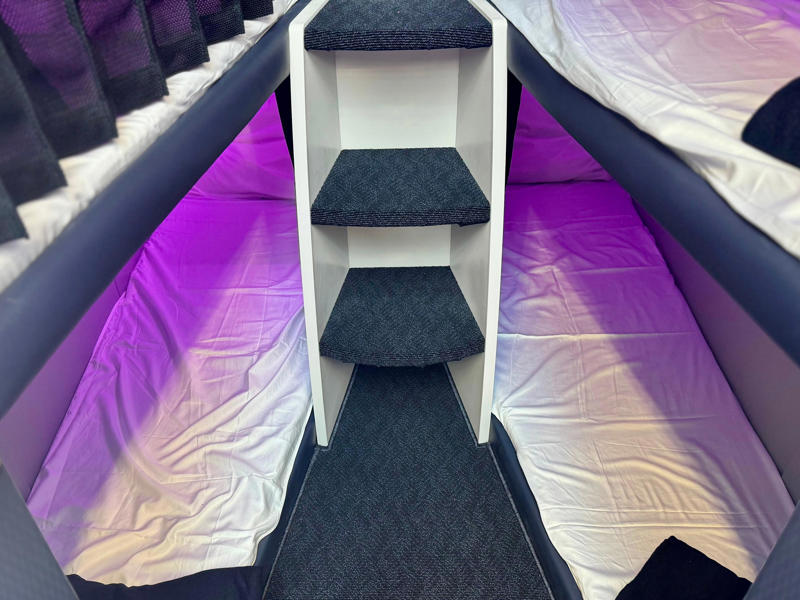 I'd prefer the bottom or middle bunks. The Skynest will be located in the middle of the plane., It features curtains, power, and a seatbelt., Flyers get soft linens and an amenity kit., I'd prefer the bottom or middle bunks., Flyers will eat before or after their block., You must be 15 or older., I'd book the Skynest to fight jet lag., The Skynest is ANZ's second economy bed.