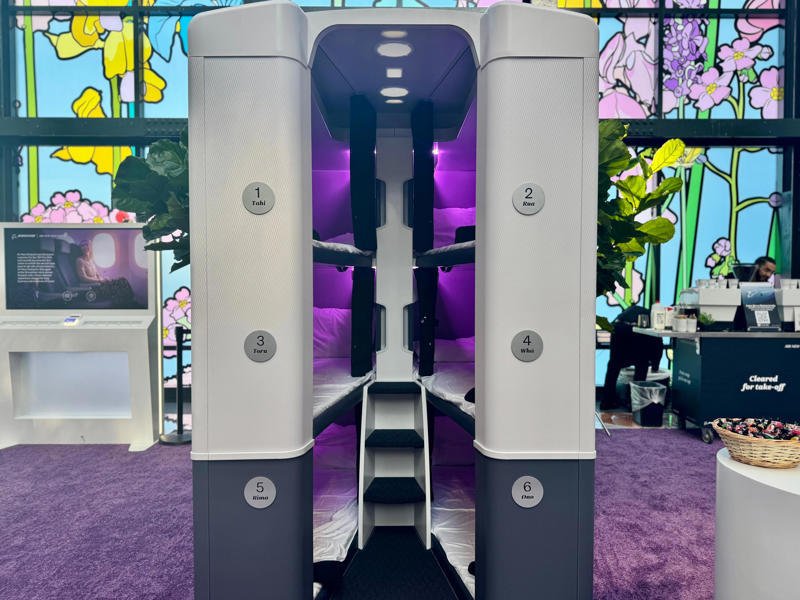 The Skynest will be located in the middle of the plane. The Skynest will be located in the middle of the plane., It features curtains, power, and a seatbelt., Flyers get soft linens and an amenity kit., I'd prefer the bottom or middle bunks., Flyers will eat before or after their block., You must be 15 or older., I'd book the Skynest to fight jet lag., The Skynest is ANZ's second economy bed.