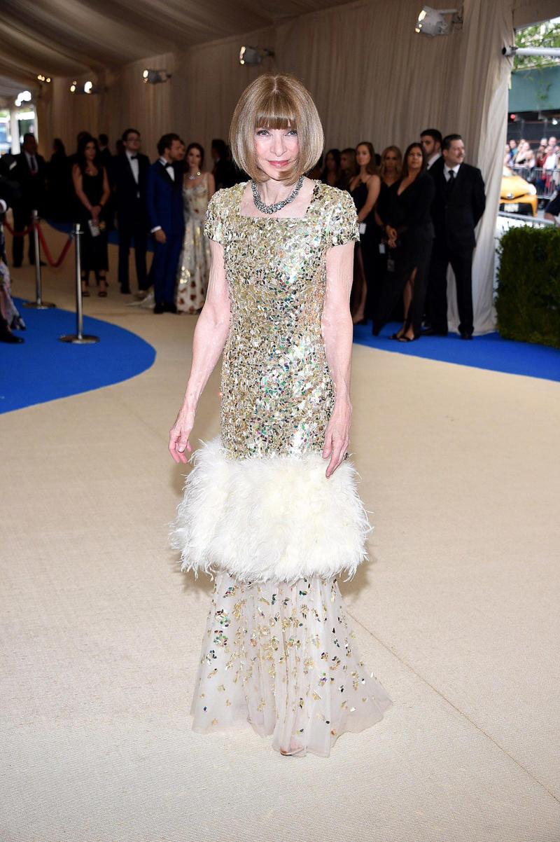 Wintour wore a sparkly gold top for the 1989 Met Gala., Wintour arrived in an angelic Christian Dior ensemble for the 2003 Met Gala., Wintour dazzled at the 2010 Met Gala in a silver-tiered Chanel dress., She returned to wearing Chanel at the 2022 Met Gala, emphasizing "Gilded Glamour."