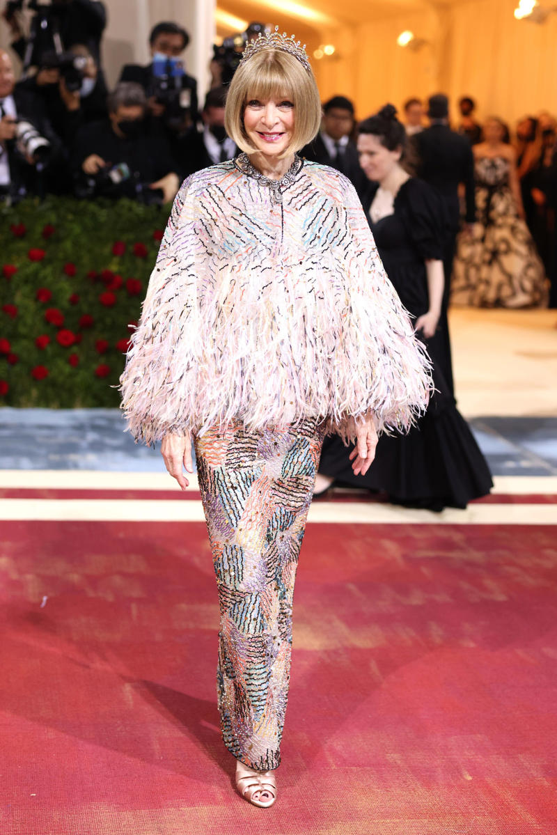 Wintour wore a sparkly gold top for the 1989 Met Gala., Wintour arrived in an angelic Christian Dior ensemble for the 2003 Met Gala., Wintour dazzled at the 2010 Met Gala in a silver-tiered Chanel dress., She returned to wearing Chanel at the 2022 Met Gala, emphasizing "Gilded Glamour."
