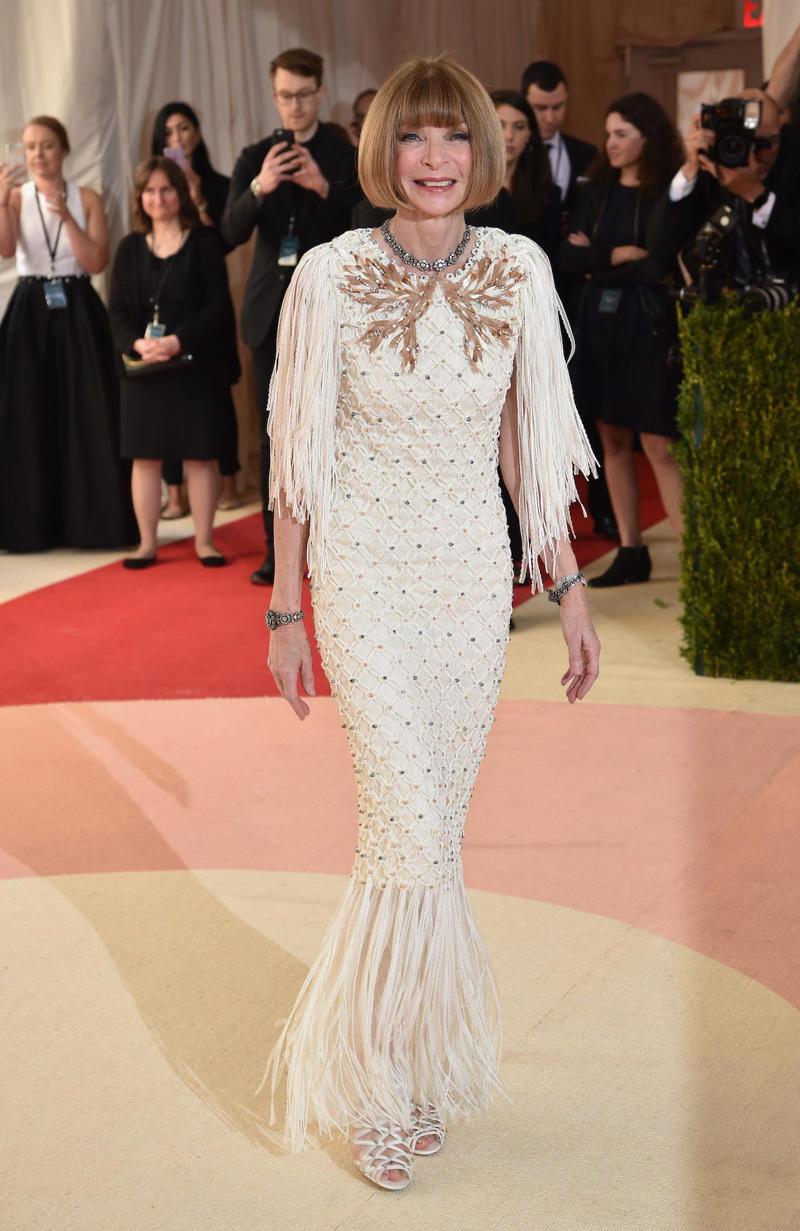 Wintour wore a sparkly gold top for the 1989 Met Gala., Wintour arrived in an angelic Christian Dior ensemble for the 2003 Met Gala., Wintour dazzled at the 2010 Met Gala in a silver-tiered Chanel dress., She returned to wearing Chanel at the 2022 Met Gala, emphasizing "Gilded Glamour."