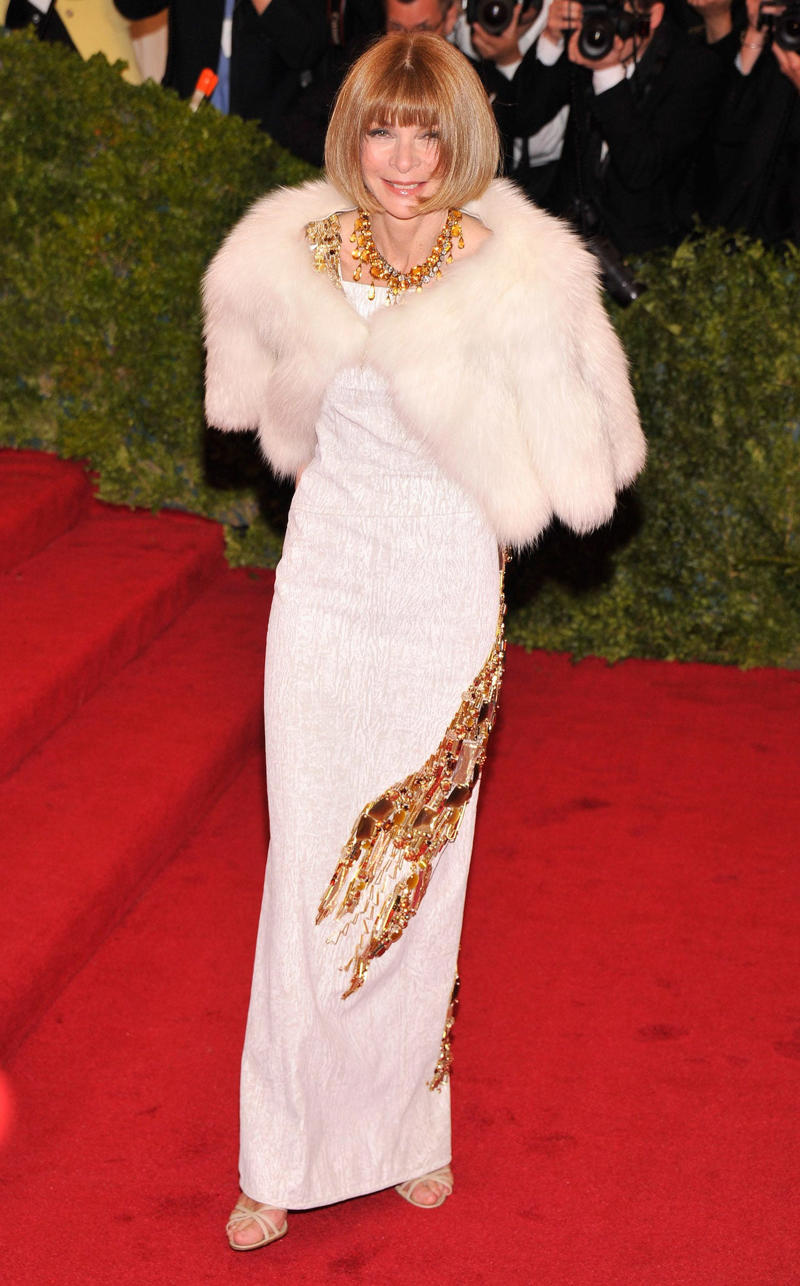 Wintour wore a sparkly gold top for the 1989 Met Gala., Wintour arrived in an angelic Christian Dior ensemble for the 2003 Met Gala., Wintour dazzled at the 2010 Met Gala in a silver-tiered Chanel dress., She returned to wearing Chanel at the 2022 Met Gala, emphasizing "Gilded Glamour."