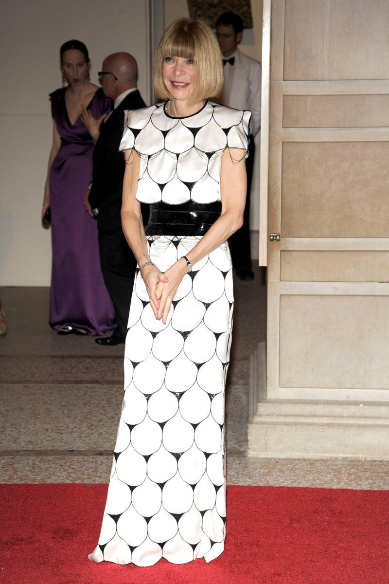 Wintour wore a sparkly gold top for the 1989 Met Gala., Wintour arrived in an angelic Christian Dior ensemble for the 2003 Met Gala., Wintour dazzled at the 2010 Met Gala in a silver-tiered Chanel dress., She returned to wearing Chanel at the 2022 Met Gala, emphasizing "Gilded Glamour."