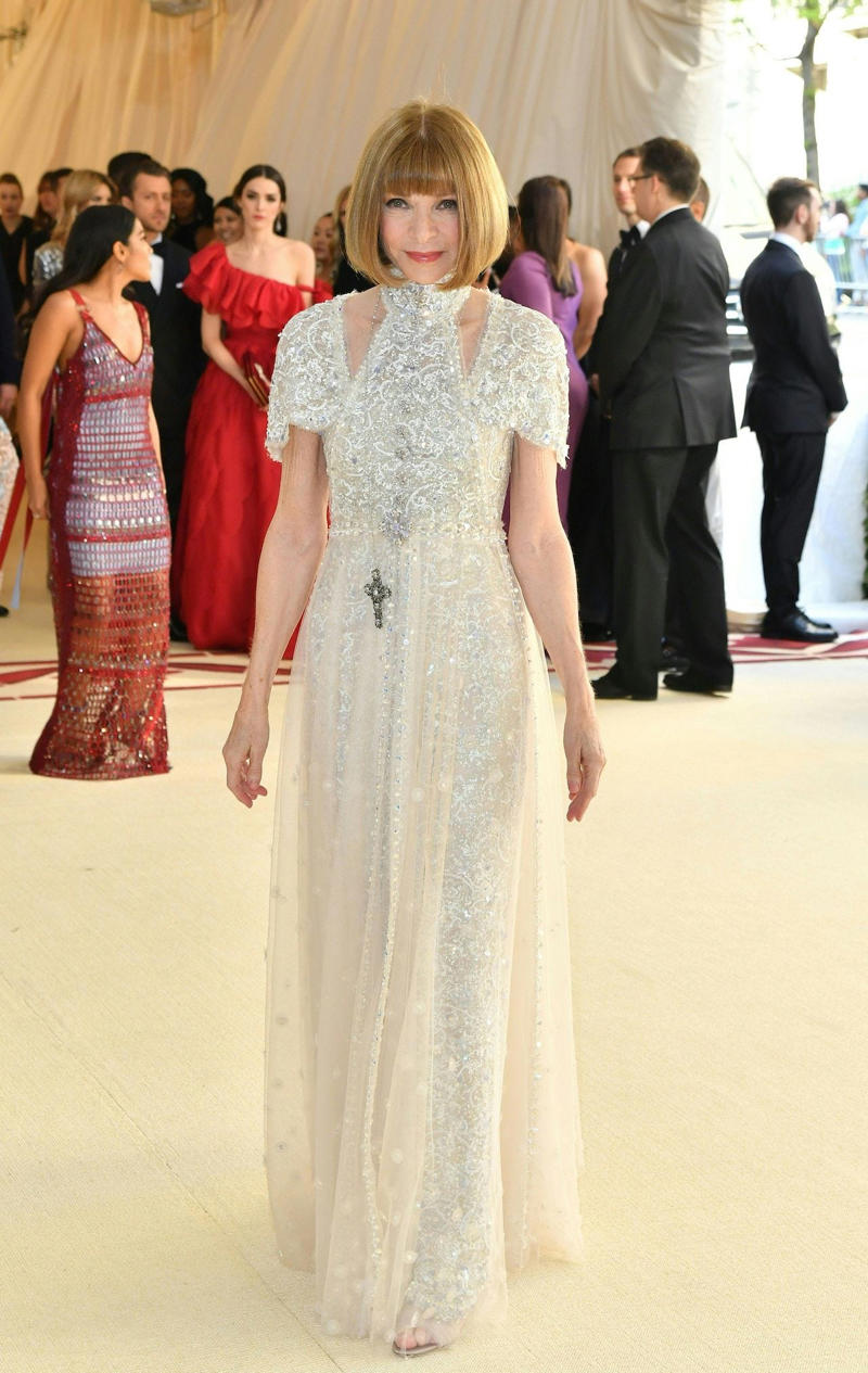Wintour wore a sparkly gold top for the 1989 Met Gala., Wintour arrived in an angelic Christian Dior ensemble for the 2003 Met Gala., Wintour dazzled at the 2010 Met Gala in a silver-tiered Chanel dress., She returned to wearing Chanel at the 2022 Met Gala, emphasizing "Gilded Glamour."