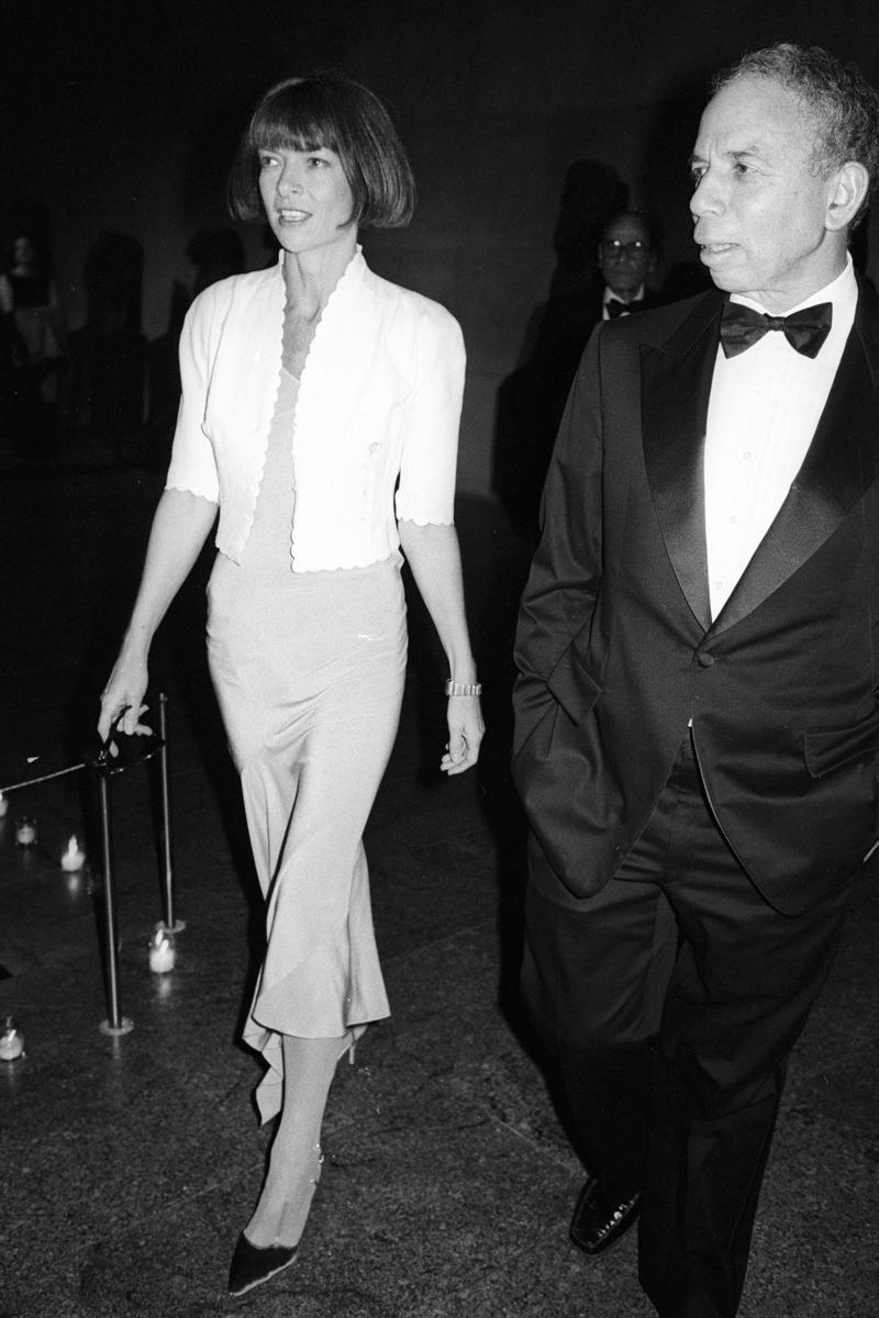 Wintour wore a sparkly gold top for the 1989 Met Gala., Wintour arrived in an angelic Christian Dior ensemble for the 2003 Met Gala., Wintour dazzled at the 2010 Met Gala in a silver-tiered Chanel dress., She returned to wearing Chanel at the 2022 Met Gala, emphasizing "Gilded Glamour."