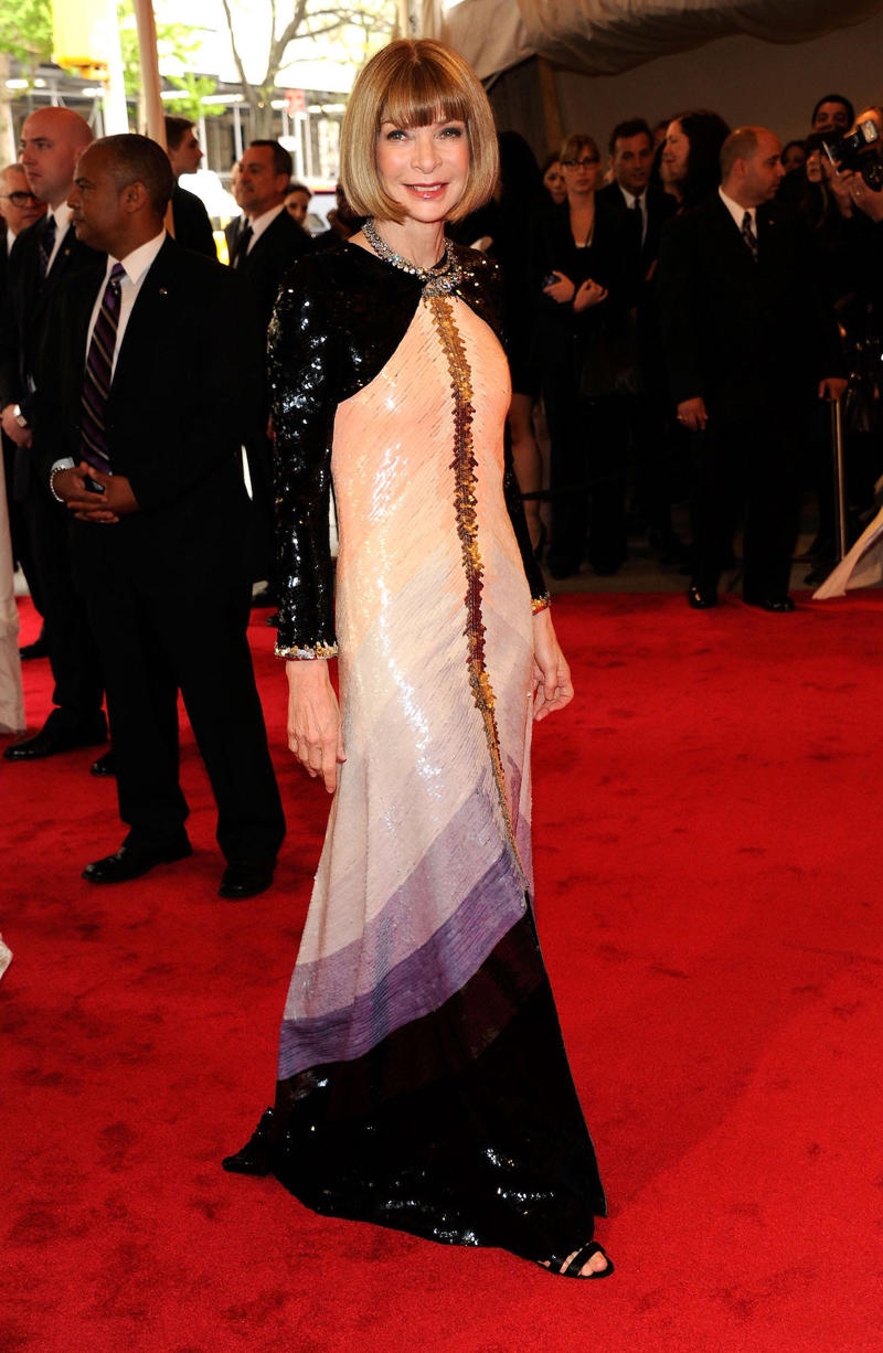Wintour wore a sparkly gold top for the 1989 Met Gala., Wintour arrived in an angelic Christian Dior ensemble for the 2003 Met Gala., Wintour dazzled at the 2010 Met Gala in a silver-tiered Chanel dress., She returned to wearing Chanel at the 2022 Met Gala, emphasizing "Gilded Glamour."