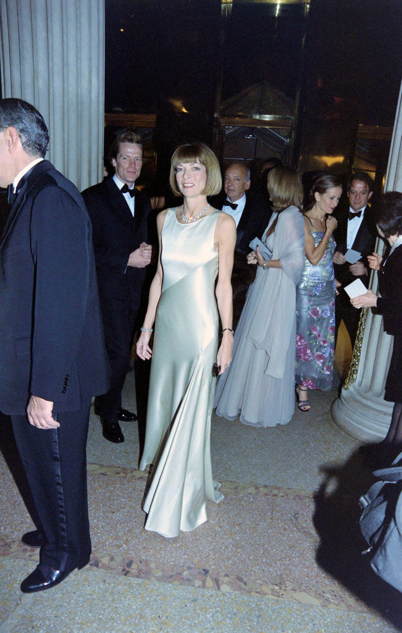 Wintour wore a sparkly gold top for the 1989 Met Gala., Wintour arrived in an angelic Christian Dior ensemble for the 2003 Met Gala., Wintour dazzled at the 2010 Met Gala in a silver-tiered Chanel dress., She returned to wearing Chanel at the 2022 Met Gala, emphasizing "Gilded Glamour."