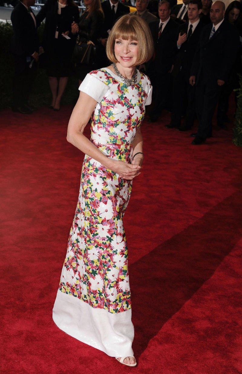 Wintour wore a sparkly gold top for the 1989 Met Gala., Wintour arrived in an angelic Christian Dior ensemble for the 2003 Met Gala., Wintour dazzled at the 2010 Met Gala in a silver-tiered Chanel dress., She returned to wearing Chanel at the 2022 Met Gala, emphasizing "Gilded Glamour."