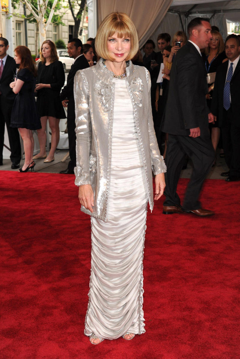Wintour wore a sparkly gold top for the 1989 Met Gala., Wintour arrived in an angelic Christian Dior ensemble for the 2003 Met Gala., Wintour dazzled at the 2010 Met Gala in a silver-tiered Chanel dress., She returned to wearing Chanel at the 2022 Met Gala, emphasizing "Gilded Glamour."