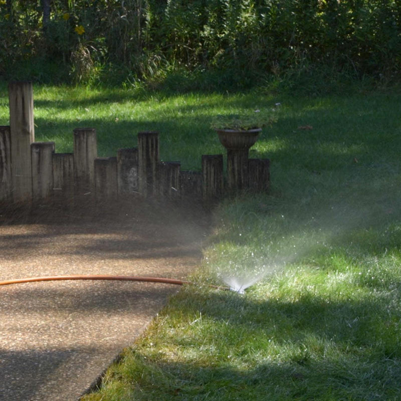 Power Wash the Slab, Load Up Pump Sprayer, dampening concrete, scrubbing concrete with stiff brush, soaking grass