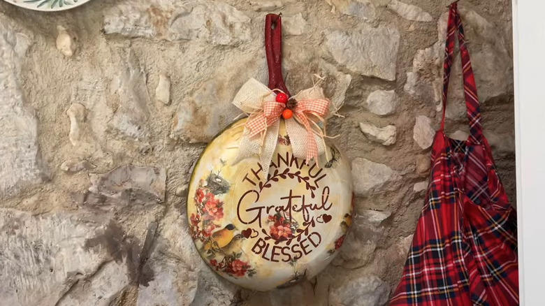 A decorative decoupage bowl, Hanging a decorated old frying pan, A tiny portable fire pit, Baking pan candle sconces, A vertical frying pan planter, Bundt cake pan planter, Sheet pan cookbook stand, Pizza pan wreath or sign