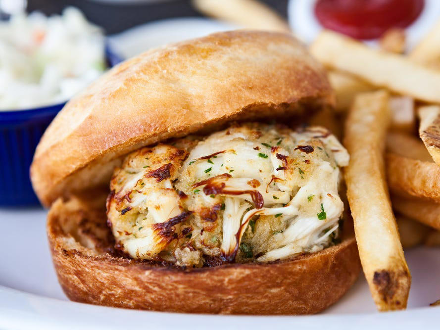 MARYLAND: A crab cake sandwich ALABAMA: A chicken sandwich with white barbecue sauce, ALASKA: A wild Alaskan salmon sandwich, ARIZONA: Frybread tacos, ARKANSAS: A deep-fried catfish sandwich, CALIFORNIA: An avocado club sandwich, COLORADO: A Denver sandwich, CONNECTICUT: A Connecticut hamburger, DELAWARE: A soft-shell fried crab sandwich, FLORIDA: A Cuban sandwich, GEORGIA: A fried chicken sandwich, HAWAII: A Kālua-style pork sandwich, ILLINOIS: A Horseshoe sandwich, INDIANA: A Hoosier sandwich, IOWA: A Tavern or "loose meat" sandwich, KANSAS: "Runza" or "bierocks", KENTUCKY: A Hot Brown sandwich, LOUISIANA: A po'boy, MARYLAND: A crab-cake sandwich, MASSACHUSETTS: A Fluffernutter, MICHIGAN: A corned beef sandwich, MINNESOTA: A Jucy Lucy, MISSISSIPPI: A pig-ear sandwich, MISSOURI: A Gerber sandwich, MONTANA: A PB&J with huckleberry jam, NEBRASKA: A Reuben, NEVADA: A Heart Attack Grill burger, NEW HAMPSHIRE: A fried ham and cheese Monte Cristo drizzled with syrup, NEW JERSEY: A Jersey breakfast sandwich, NEW MEXICO: A green chile cheeseburger, NORTH CAROLINA: A pulled-pork sandwich, NORTH DAKOTA: Smørbrød, OHIO: A Polish boy, OKLAHOMA: A chicken-fried steak sandwich, OREGON: A falafel pita, PENNSYLVANIA: A Philly cheesesteak, RHODE ISLAND: A Dynamite sandwich, SOUTH CAROLINA: A tuna melt, SOUTH DAKOTA: A walleye sandwich, TENNESSEE: A Fluffernutter, TEXAS: A brisket sandwich, UTAH: A pastrami burger, VERMONT: A Vermonter, VIRGINIA: A grilled ham and cheese, WASHINGTON: Bánh mì, WEST VIRGINIA: An apple and turkey sandwich, WISCONSIN: A sausage roll or brat bun, WYOMING: A bison meatball sandwich