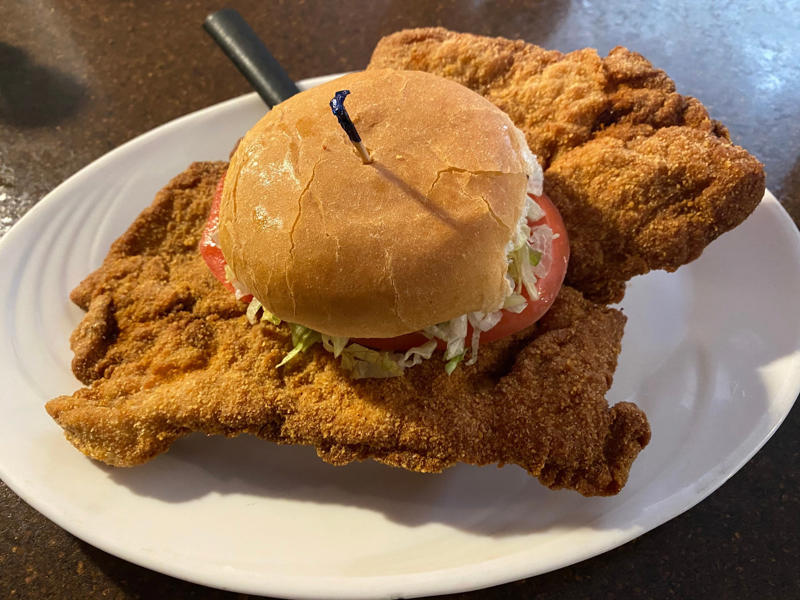 INDIANA: A Hoosier sandwich ALABAMA: A chicken sandwich with white barbecue sauce, ALASKA: A wild Alaskan salmon sandwich, ARIZONA: Frybread tacos, ARKANSAS: A deep-fried catfish sandwich, CALIFORNIA: An avocado club sandwich, COLORADO: A Denver sandwich, CONNECTICUT: A Connecticut hamburger, DELAWARE: A soft-shell fried crab sandwich, FLORIDA: A Cuban sandwich, GEORGIA: A fried chicken sandwich, HAWAII: A Kālua-style pork sandwich, ILLINOIS: A Horseshoe sandwich, INDIANA: A Hoosier sandwich, IOWA: A Tavern or "loose meat" sandwich, KANSAS: "Runza" or "bierocks", KENTUCKY: A Hot Brown sandwich, LOUISIANA: A po'boy, MARYLAND: A crab-cake sandwich, MASSACHUSETTS: A Fluffernutter, MICHIGAN: A corned beef sandwich, MINNESOTA: A Jucy Lucy, MISSISSIPPI: A pig-ear sandwich, MISSOURI: A Gerber sandwich, MONTANA: A PB&J with huckleberry jam, NEBRASKA: A Reuben, NEVADA: A Heart Attack Grill burger, NEW HAMPSHIRE: A fried ham and cheese Monte Cristo drizzled with syrup, NEW JERSEY: A Jersey breakfast sandwich, NEW MEXICO: A green chile cheeseburger, NORTH CAROLINA: A pulled-pork sandwich, NORTH DAKOTA: Smørbrød, OHIO: A Polish boy, OKLAHOMA: A chicken-fried steak sandwich, OREGON: A falafel pita, PENNSYLVANIA: A Philly cheesesteak, RHODE ISLAND: A Dynamite sandwich, SOUTH CAROLINA: A tuna melt, SOUTH DAKOTA: A walleye sandwich, TENNESSEE: A Fluffernutter, TEXAS: A brisket sandwich, UTAH: A pastrami burger, VERMONT: A Vermonter, VIRGINIA: A grilled ham and cheese, WASHINGTON: Bánh mì, WEST VIRGINIA: An apple and turkey sandwich, WISCONSIN: A sausage roll or brat bun, WYOMING: A bison meatball sandwich