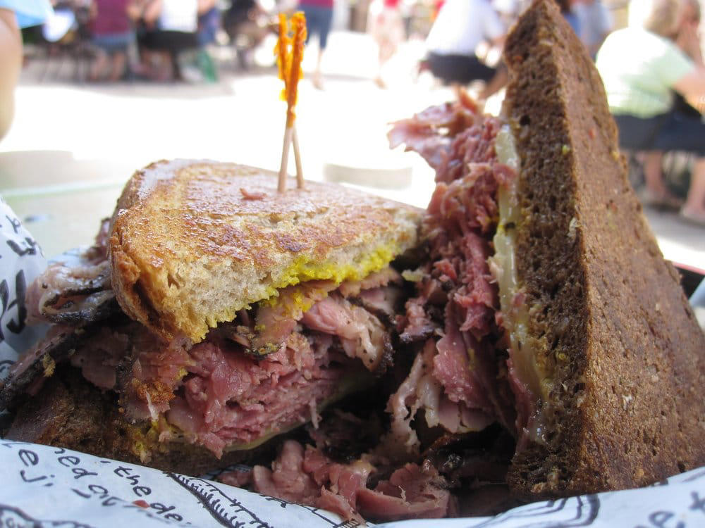 MICHIGAN: A corned beef sandwich ALABAMA: A chicken sandwich with white barbecue sauce, ALASKA: A wild Alaskan salmon sandwich, ARIZONA: Frybread tacos, ARKANSAS: A deep-fried catfish sandwich, CALIFORNIA: An avocado club sandwich, COLORADO: A Denver sandwich, CONNECTICUT: A Connecticut hamburger, DELAWARE: A soft-shell fried crab sandwich, FLORIDA: A Cuban sandwich, GEORGIA: A fried chicken sandwich, HAWAII: A Kālua-style pork sandwich, ILLINOIS: A Horseshoe sandwich, INDIANA: A Hoosier sandwich, IOWA: A Tavern or "loose meat" sandwich, KANSAS: "Runza" or "bierocks", KENTUCKY: A Hot Brown sandwich, LOUISIANA: A po'boy, MARYLAND: A crab-cake sandwich, MASSACHUSETTS: A Fluffernutter, MICHIGAN: A corned beef sandwich, MINNESOTA: A Jucy Lucy, MISSISSIPPI: A pig-ear sandwich, MISSOURI: A Gerber sandwich, MONTANA: A PB&J with huckleberry jam, NEBRASKA: A Reuben, NEVADA: A Heart Attack Grill burger, NEW HAMPSHIRE: A fried ham and cheese Monte Cristo drizzled with syrup, NEW JERSEY: A Jersey breakfast sandwich, NEW MEXICO: A green chile cheeseburger, NORTH CAROLINA: A pulled-pork sandwich, NORTH DAKOTA: Smørbrød, OHIO: A Polish boy, OKLAHOMA: A chicken-fried steak sandwich, OREGON: A falafel pita, PENNSYLVANIA: A Philly cheesesteak, RHODE ISLAND: A Dynamite sandwich, SOUTH CAROLINA: A tuna melt, SOUTH DAKOTA: A walleye sandwich, TENNESSEE: A Fluffernutter, TEXAS: A brisket sandwich, UTAH: A pastrami burger, VERMONT: A Vermonter, VIRGINIA: A grilled ham and cheese, WASHINGTON: Bánh mì, WEST VIRGINIA: An apple and turkey sandwich, WISCONSIN: A sausage roll or brat bun, WYOMING: A bison meatball sandwich