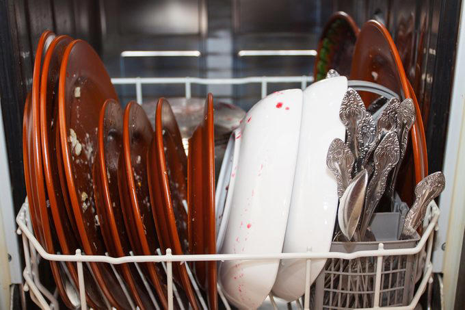 Not cleaning or overcleaning dishes before loading them, Abusing the door, Using too much detergent, Running small loads, Forgetting to replace the hose, Using hard water, Avoiding regular inspections, Putting sharp objects in the racks, Leaving broken glass in the bottom, Overloading it, Using the delay cycle, Forgetting to empty the food trap, Running through candle holders without removing melted wax, Putting in items that are too dirty, Skipping surge protectors, Not using a dishwasher cleaning product, Using cheap dishwasher products, Forgetting to lock the filter at the bottom of the dishwasher, Neglecting to clean the dishwasher screen, Running the wrong cycle type, Loading it incorrectly