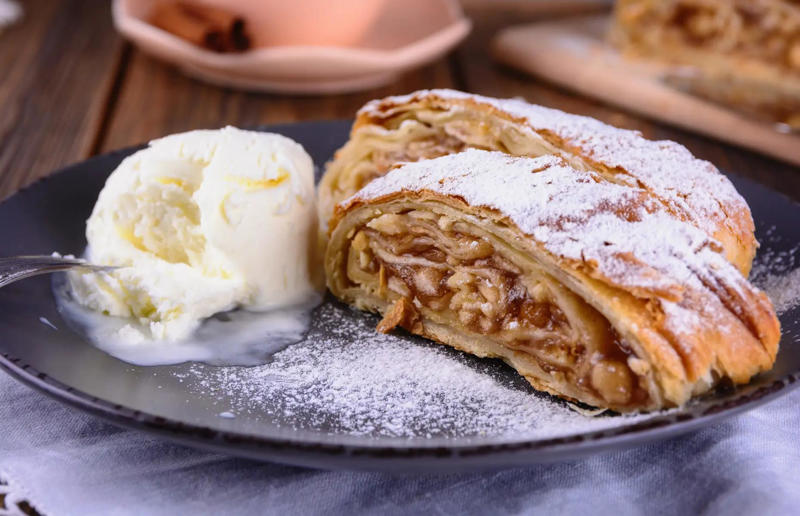 4. Apfelstrudel, Austria 61. Rigó Jancsi, Hungary, 60. Sorbet, various locations, 59. Sticky rice with mango, Thailand, 58. Ma’amoul, Egypt, 57. M’hanncha, Morocco, 56. Vermicelles, France, Italy and Switzerland, 55. Thapthim krop, Thailand, 54. S’mores, USA, 53. Dadar gulung, Indonesia, 52. Cannoli, Italy, 51. Crème caramel, France, 50. Rum cake, Caribbean, 49. Torrijas, Spain, 48. Malva pudding, South Africa, 47. Koeksister, South Africa, 46. Carlota de limón, Mexico, 45. Banoffee pie, England, UK, 44. Alfajores, South America, 43. Doughnuts, various locations, 42. Medovik, Russia, 41. Crumble, UK, 40. Lamington, Australia, 39. Bread and butter pudding, England, UK, 38. Profiteroles, France, 37. Galaktoboureko, various locations, 36. Gelato, Italy, 35. Churros, Spain and Portugal, 34. Gulab jamun, India, 33. Trifle, England, UK, 32. Snow ice, Taiwan, 31. Red velvet cake, USA, 30. Crêpes Suzette, France, 29. Bienenstich, Germany, 28. Chocolate soufflé, France, 27. Baked Alaska, USA, 26. Mooncakes, China, 25. Panna cotta, Italy, 24. Qatayef, Middle East, 23. Eton mess, England, UK, 22. Pecan pie, USA, 21. Pavlova, Australia or New Zealand, 20. Brownies, USA, 19. Rote grütze, Germany, 18. Tarte Tatin, France, 17. Kulfi, India, 16. Tiramisù, Italy, 15. Crème brûlée, France, 14. Frozen yogurt, USA, 13. Sticky toffee pudding, UK, 12. Black Forest gâteau, Germany, 11. Nanaimo bar, Canada, 10. Cendol, Southeast Asia, 9. Mochi, Japan, 8. Tres leches cake, Latin America, 7. Baklava, Türkiye, 6. Key lime pie, USA, 5. Chocolate mousse, France, 4. Apfelstrudel, Austria, 3. Apple pie, various locations, 2. Cheesecake, various locations