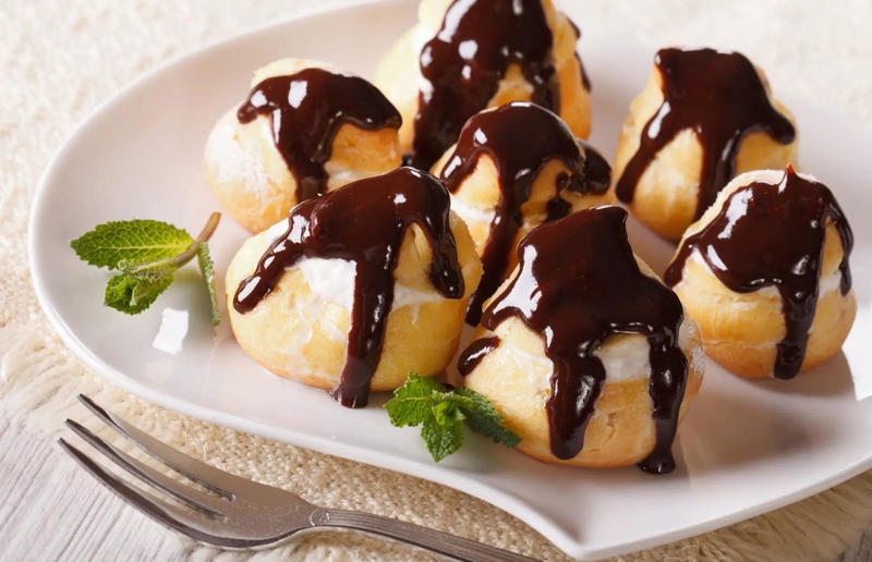 37. Profiteroles, France 61. Rigó Jancsi, Hungary, 60. Sorbet, various locations, 59. Sticky rice with mango, Thailand, 58. Ma’amoul, Egypt, 57. M’hanncha, Morocco, 56. Vermicelles, France, Italy and Switzerland, 55. Thapthim krop, Thailand, 54. S’mores, USA, 53. Dadar gulung, Indonesia, 52. Cannoli, Italy, 51. Crème caramel, France, 50. Rum cake, Caribbean, 49. Torrijas, Spain, 48. Malva pudding, South Africa, 47. Koeksister, South Africa, 46. Carlota de limón, Mexico, 45. Banoffee pie, England, UK, 44. Alfajores, South America, 43. Doughnuts, various locations, 42. Medovik, Russia, 41. Crumble, UK, 40. Lamington, Australia, 39. Bread and butter pudding, England, UK, 38. Profiteroles, France, 37. Galaktoboureko, various locations, 36. Gelato, Italy, 35. Churros, Spain and Portugal, 34. Gulab jamun, India, 33. Trifle, England, UK, 32. Snow ice, Taiwan, 31. Red velvet cake, USA, 30. Crêpes Suzette, France, 29. Bienenstich, Germany, 28. Chocolate soufflé, France, 27. Baked Alaska, USA, 26. Mooncakes, China, 25. Panna cotta, Italy, 24. Qatayef, Middle East, 23. Eton mess, England, UK, 22. Pecan pie, USA, 21. Pavlova, Australia or New Zealand, 20. Brownies, USA, 19. Rote grütze, Germany, 18. Tarte Tatin, France, 17. Kulfi, India, 16. Tiramisù, Italy, 15. Crème brûlée, France, 14. Frozen yogurt, USA, 13. Sticky toffee pudding, UK, 12. Black Forest gâteau, Germany, 11. Nanaimo bar, Canada, 10. Cendol, Southeast Asia, 9. Mochi, Japan, 8. Tres leches cake, Latin America, 7. Baklava, Türkiye, 6. Key lime pie, USA, 5. Chocolate mousse, France, 4. Apfelstrudel, Austria, 3. Apple pie, various locations, 2. Cheesecake, various locations