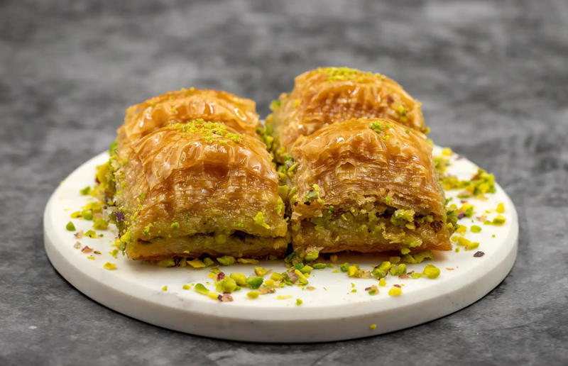 7. Baklava, Turkey 61. Rigó Jancsi, Hungary, 60. Sorbet, various locations, 59. Sticky rice with mango, Thailand, 58. Ma’amoul, Egypt, 57. M’hanncha, Morocco, 56. Vermicelles, France, Italy and Switzerland, 55. Thapthim krop, Thailand, 54. S’mores, USA, 53. Dadar gulung, Indonesia, 52. Cannoli, Italy, 51. Crème caramel, France, 50. Rum cake, Caribbean, 49. Torrijas, Spain, 48. Malva pudding, South Africa, 47. Koeksister, South Africa, 46. Carlota de limón, Mexico, 45. Banoffee pie, England, UK, 44. Alfajores, South America, 43. Doughnuts, various locations, 42. Medovik, Russia, 41. Crumble, UK, 40. Lamington, Australia, 39. Bread and butter pudding, England, UK, 38. Profiteroles, France, 37. Galaktoboureko, various locations, 36. Gelato, Italy, 35. Churros, Spain and Portugal, 34. Gulab jamun, India, 33. Trifle, England, UK, 32. Snow ice, Taiwan, 31. Red velvet cake, USA, 30. Crêpes Suzette, France, 29. Bienenstich, Germany, 28. Chocolate soufflé, France, 27. Baked Alaska, USA, 26. Mooncakes, China, 25. Panna cotta, Italy, 24. Qatayef, Middle East, 23. Eton mess, England, UK, 22. Pecan pie, USA, 21. Pavlova, Australia or New Zealand, 20. Brownies, USA, 19. Rote grütze, Germany, 18. Tarte Tatin, France, 17. Kulfi, India, 16. Tiramisù, Italy, 15. Crème brûlée, France, 14. Frozen yogurt, USA, 13. Sticky toffee pudding, UK, 12. Black Forest gâteau, Germany, 11. Nanaimo bar, Canada, 10. Cendol, Southeast Asia, 9. Mochi, Japan, 8. Tres leches cake, Latin America, 7. Baklava, Türkiye, 6. Key lime pie, USA, 5. Chocolate mousse, France, 4. Apfelstrudel, Austria, 3. Apple pie, various locations, 2. Cheesecake, various locations