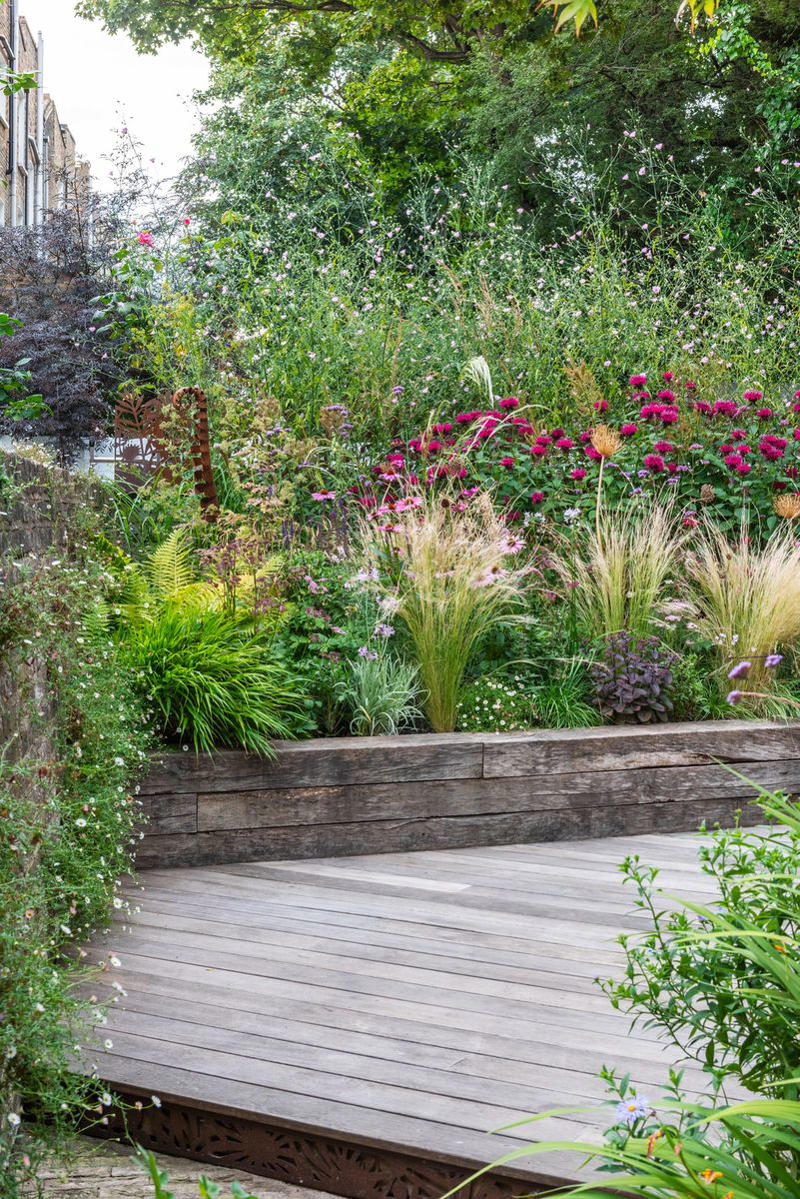1) Make Them Waist Height, 3) Carve a Path, 4) Add Grid Wiring, 5) Use Brick, 10) Build in Steps, 11) Spring for Stone, 13) Choose Colorful Planters, 16) Make Your Own Meadow, 19) Opt for a Bucket, 20) Try Square Foot Gardening, 21) Surround a Shed, 22) Mix the Materials, 23) Work the Angles, 25) Tier the Planters, 26) Incorporate Scenic Pathways, 27) Mix and Match Your Vessels, 28) Think Outside the Box, 29) Automate Your Chores, 30) Add a Bit of Quirk