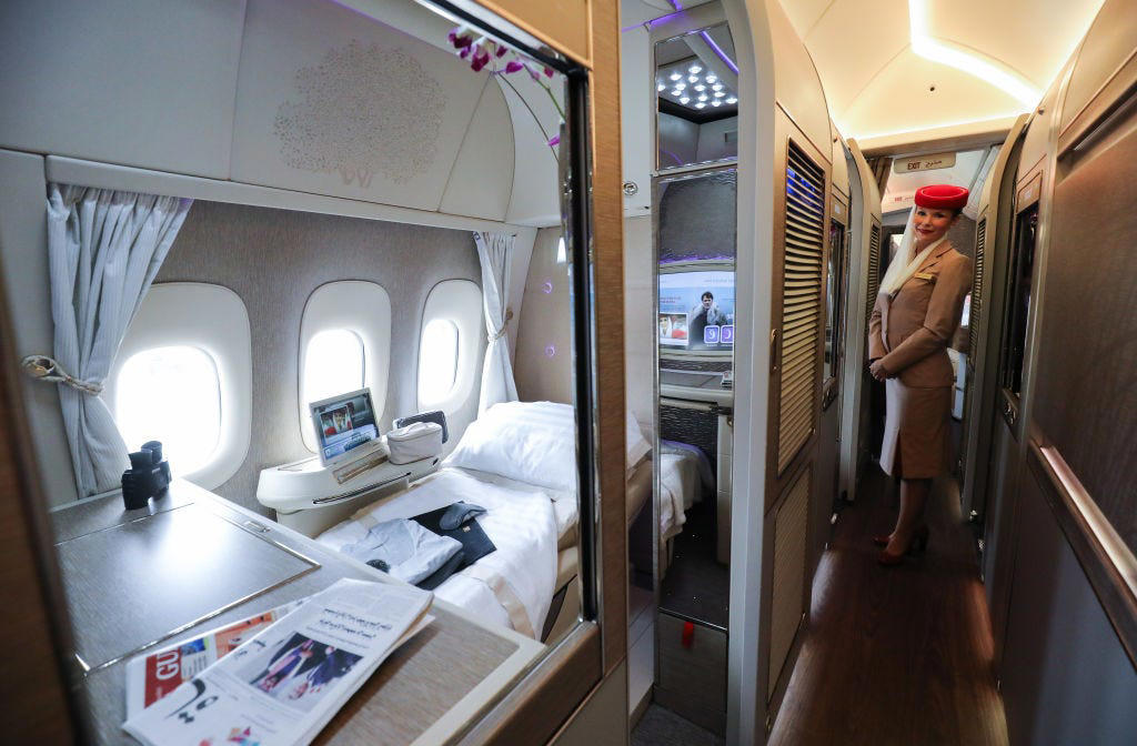 Reclining seats included footrests and leaned almost all the way back., The first-class cabin's gourmet dining remained., Flutes of Champagne were an added bonus., Spiral staircases led to the 747's upper deck lounge., Some early jumbo jets were even equipped with pianos., The massive double-decker entered service with Singapore Airlines in 2007., Two suites could even be merged to create a couple's suite., Emirates has also launched its own first-class suites., Amenities include access to an in-flight shower., However, the ultimate first-class experience comes courtesy of Etihad., Each 125-square-foot, three-room suite features an en suite bathroom with a shower., It also includes a private bedroom and a personal butler., Two suites can be joined to create a two-passenger mega-suite.
