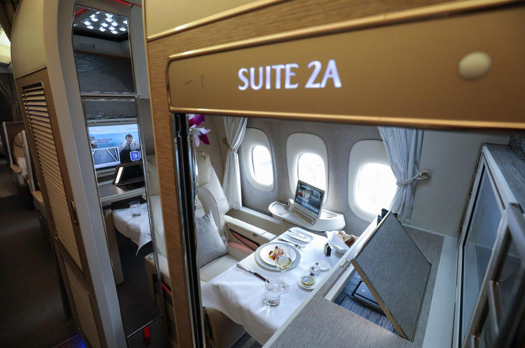 Reclining seats included footrests and leaned almost all the way back., The first-class cabin's gourmet dining remained., Flutes of Champagne were an added bonus., Spiral staircases led to the 747's upper deck lounge., Some early jumbo jets were even equipped with pianos., The massive double-decker entered service with Singapore Airlines in 2007., Two suites could even be merged to create a couple's suite., Emirates has also launched its own first-class suites., Amenities include access to an in-flight shower., However, the ultimate first-class experience comes courtesy of Etihad., Each 125-square-foot, three-room suite features an en suite bathroom with a shower., It also includes a private bedroom and a personal butler., Two suites can be joined to create a two-passenger mega-suite.
