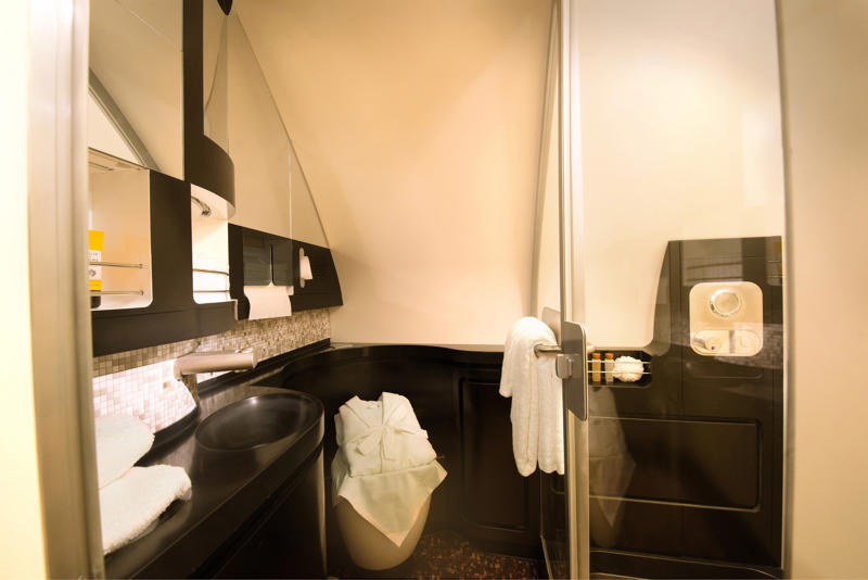 Reclining seats included footrests and leaned almost all the way back., The first-class cabin's gourmet dining remained., Flutes of Champagne were an added bonus., Spiral staircases led to the 747's upper deck lounge., Some early jumbo jets were even equipped with pianos., The massive double-decker entered service with Singapore Airlines in 2007., Two suites could even be merged to create a couple's suite., Emirates has also launched its own first-class suites., Amenities include access to an in-flight shower., However, the ultimate first-class experience comes courtesy of Etihad., Each 125-square-foot, three-room suite features an en suite bathroom with a shower., It also includes a private bedroom and a personal butler., Two suites can be joined to create a two-passenger mega-suite.
