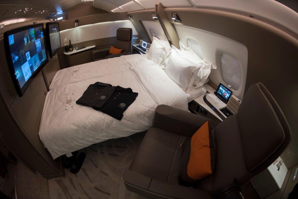 Reclining seats included footrests and leaned almost all the way back., The first-class cabin's gourmet dining remained., Flutes of Champagne were an added bonus., Spiral staircases led to the 747's upper deck lounge., Some early jumbo jets were even equipped with pianos., The massive double-decker entered service with Singapore Airlines in 2007., Two suites could even be merged to create a couple's suite., Emirates has also launched its own first-class suites., Amenities include access to an in-flight shower., However, the ultimate first-class experience comes courtesy of Etihad., Each 125-square-foot, three-room suite features an en suite bathroom with a shower., It also includes a private bedroom and a personal butler., Two suites can be joined to create a two-passenger mega-suite.