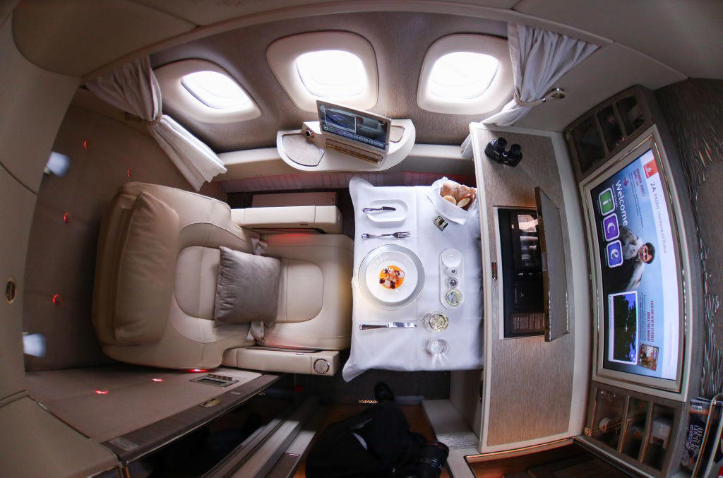 Reclining seats included footrests and leaned almost all the way back., The first-class cabin's gourmet dining remained., Flutes of Champagne were an added bonus., Spiral staircases led to the 747's upper deck lounge., Some early jumbo jets were even equipped with pianos., The massive double-decker entered service with Singapore Airlines in 2007., Two suites could even be merged to create a couple's suite., Emirates has also launched its own first-class suites., Amenities include access to an in-flight shower., However, the ultimate first-class experience comes courtesy of Etihad., Each 125-square-foot, three-room suite features an en suite bathroom with a shower., It also includes a private bedroom and a personal butler., Two suites can be joined to create a two-passenger mega-suite.