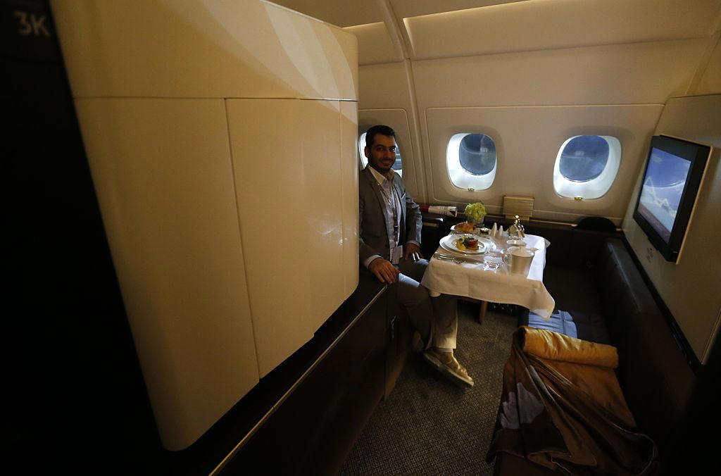 Reclining seats included footrests and leaned almost all the way back., The first-class cabin's gourmet dining remained., Flutes of Champagne were an added bonus., Spiral staircases led to the 747's upper deck lounge., Some early jumbo jets were even equipped with pianos., The massive double-decker entered service with Singapore Airlines in 2007., Two suites could even be merged to create a couple's suite., Emirates has also launched its own first-class suites., Amenities include access to an in-flight shower., However, the ultimate first-class experience comes courtesy of Etihad., Each 125-square-foot, three-room suite features an en suite bathroom with a shower., It also includes a private bedroom and a personal butler., Two suites can be joined to create a two-passenger mega-suite.