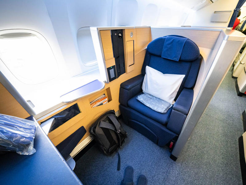Reclining seats included footrests and leaned almost all the way back., The first-class cabin's gourmet dining remained., Flutes of Champagne were an added bonus., Spiral staircases led to the 747's upper deck lounge., Some early jumbo jets were even equipped with pianos., The massive double-decker entered service with Singapore Airlines in 2007., Two suites could even be merged to create a couple's suite., Emirates has also launched its own first-class suites., Amenities include access to an in-flight shower., However, the ultimate first-class experience comes courtesy of Etihad., Each 125-square-foot, three-room suite features an en suite bathroom with a shower., It also includes a private bedroom and a personal butler., Two suites can be joined to create a two-passenger mega-suite.