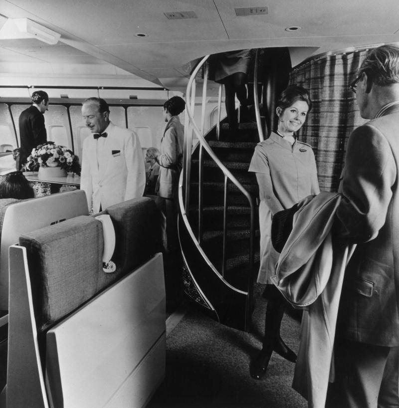 Reclining seats included footrests and leaned almost all the way back., The first-class cabin's gourmet dining remained., Flutes of Champagne were an added bonus., Spiral staircases led to the 747's upper deck lounge., Some early jumbo jets were even equipped with pianos., The massive double-decker entered service with Singapore Airlines in 2007., Two suites could even be merged to create a couple's suite., Emirates has also launched its own first-class suites., Amenities include access to an in-flight shower., However, the ultimate first-class experience comes courtesy of Etihad., Each 125-square-foot, three-room suite features an en suite bathroom with a shower., It also includes a private bedroom and a personal butler., Two suites can be joined to create a two-passenger mega-suite.