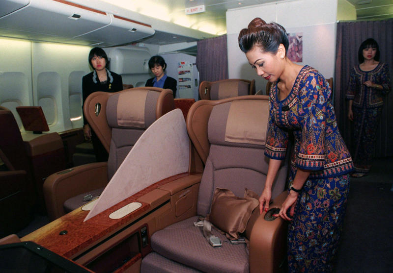Reclining seats included footrests and leaned almost all the way back., The first-class cabin's gourmet dining remained., Flutes of Champagne were an added bonus., Spiral staircases led to the 747's upper deck lounge., Some early jumbo jets were even equipped with pianos., The massive double-decker entered service with Singapore Airlines in 2007., Two suites could even be merged to create a couple's suite., Emirates has also launched its own first-class suites., Amenities include access to an in-flight shower., However, the ultimate first-class experience comes courtesy of Etihad., Each 125-square-foot, three-room suite features an en suite bathroom with a shower., It also includes a private bedroom and a personal butler., Two suites can be joined to create a two-passenger mega-suite.