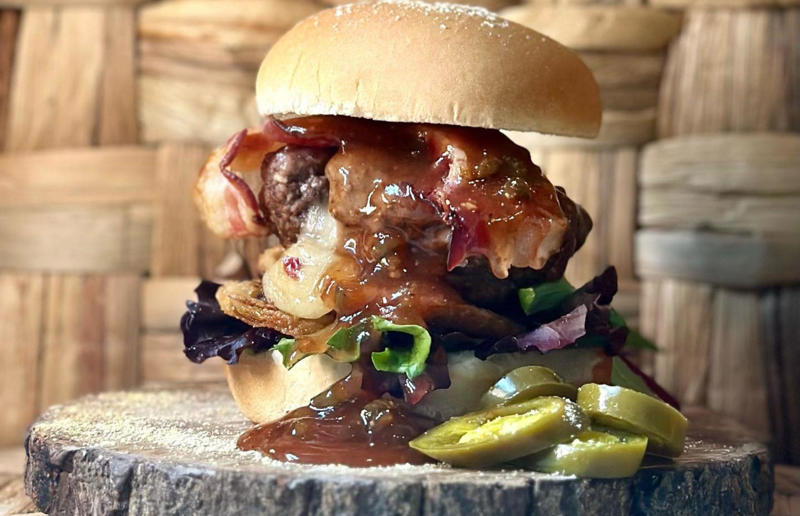 Wisconsin: Tequila Jam Burger, 11:11 Burgers & Beignets, Fond Du Lac, Wisconsin Bacon with EVERYTHING, Alabama: BALT, Urban Cookhouse, various locations, Alaska: Fat Elvis milkshake, Snow City Cafe, Anchorage, Arizona: stuffed Medjool dates, J.T. Prime Kitchen & Cocktails, Yuma, Arkansas: Eggniter, Golden Kolache Bakery, Fayetteville, California: B’B’B’ Bacon, Slater's 50/50, various locations, Colorado: signature bacon flight, Bacon Social House, various locations, Connecticut: smoked mac & cheese, Pig Rig BBQ, Wallingford, Delaware: bacon cheese fries, m2o Burgers & Salads, Newark, District of Columbia: glazed bacon lollis, Founding Farmers, various locations, Florida: candied bacon maple ice cream, Ulele, Tampa, Georgia: BBQ bacon, Burger 21, Kennesaw and Buford, Hawaii: Fat Boy, Hank's Haute Dogs, Honolulu, Idaho: bacon, egg, and cheese breakfast tacos, Tin Roof Tacos, various locations, Illinois: cheeseburger, Au Cheval, Chicago, Indiana: BLT croissant, Rize, various locations, Iowa: pancake sandwich, The Breakfast Club, various locations, Kansas: bleu cheese and bacon burger, The Anchor, Wichita, Kentucky: maple bacon donut, Nord's Bakery, Louisville, Louisiana: Buckboard Bacon Melt, Cochon Butcher, New Orleans, Maine: bacon Cheddar, The Holy Donut, Portland, Maryland: Baltimore Burger, Abbey Burger Bistro, Baltimore and Havre de Grace, Massachusetts: 'Irish' nachos, Harry's Bar & Grill, Boston, Michigan: BLT, Tony’s I-75, Birch Run, Minnesota: Millionaire bacon burger, Granite City Food & Brewery, various locations, Mississippi: Redneck Benny, Big Bad Breakfast, Oxford, Missouri: The Combo, Songbird, St. Louis, Montana: The 'Mazatlan' Mexican Dog, The Burger Dive, Billings, Nebraska: Greatest Burger Ever, Honest Abe’s Burgers & Freedom, Lincoln, Nebraska, Nevada: 24K Burger, Slater's 50/50, Las Vegas, New Hampshire: Bacon Bene, The Bacon Barn, Londonderry, New Jersey: bacon brisket sandwich, Bake'n Bacon, Cape May, New Mexico: BB&C, Urban Hotdog Company, Albuquerque, New York: Clothesline Bacon, David Burke Tavern, New York City, North Carolina: BLT, Merritt's Grill, Chapel Hill, North Dakota: The Elvis, Bearscat Bakehouse, Bismarck and Minot, Ohio: Biscuit BLT, Dough Mama, Columbus, Oklahoma: Brussels sprouts, Packard’s, Oklahoma City, Oregon: praline bacon, Screen Door, Portland, Pennsylvania: bacon flight, Bacon, Bourbon & Beer, Washington, Rhode Island: BLT, The Malted Barley, Providence, South Carolina: candied bacon brownie, Nose Dive, Greenville, South Dakota: bacon wrapped filet mignon, Alpine Inn, Hill City, Tennessee: Southern Sampler Breakfast, The Loveless Cafe, Nashville, Texas: chicken fried bacon, Sodolak's Original Country Inn, Snook, Utah: roasted bacon wrapped dates, Midway Mercantile Restaurant, Midway, Vermont: Breakfast Mac, Our House Bistro, Winooski, Virginia: Mother Clucker, Capitol Waffle Shop, various locations, Washington: Meatza, Windy City Pie, Seattle, West Virginia: hot chicken sandwich with bacon, Wood Iron Eatery, Fayetteville, Wisconsin: tequila jam burger, 11:11 Burgers & Beignets, Fond Du Lac, Wisconsin
