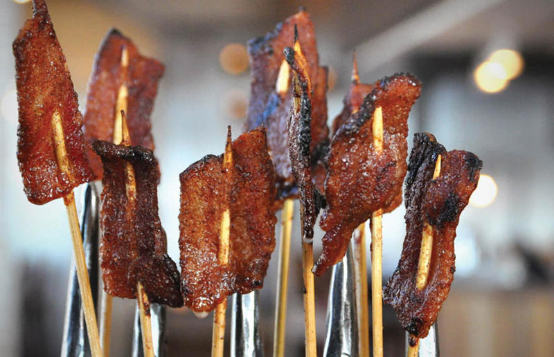 District of Columbia: Glazed Bacon Lollis, Founding Farmers, various locations Bacon with EVERYTHING, Alabama: BALT, Urban Cookhouse, various locations, Alaska: Fat Elvis milkshake, Snow City Cafe, Anchorage, Arizona: stuffed Medjool dates, J.T. Prime Kitchen & Cocktails, Yuma, Arkansas: Eggniter, Golden Kolache Bakery, Fayetteville, California: B’B’B’ Bacon, Slater's 50/50, various locations, Colorado: signature bacon flight, Bacon Social House, various locations, Connecticut: smoked mac & cheese, Pig Rig BBQ, Wallingford, Delaware: bacon cheese fries, m2o Burgers & Salads, Newark, District of Columbia: glazed bacon lollis, Founding Farmers, various locations, Florida: candied bacon maple ice cream, Ulele, Tampa, Georgia: BBQ bacon, Burger 21, Kennesaw and Buford, Hawaii: Fat Boy, Hank's Haute Dogs, Honolulu, Idaho: bacon, egg, and cheese breakfast tacos, Tin Roof Tacos, various locations, Illinois: cheeseburger, Au Cheval, Chicago, Indiana: BLT croissant, Rize, various locations, Iowa: pancake sandwich, The Breakfast Club, various locations, Kansas: bleu cheese and bacon burger, The Anchor, Wichita, Kentucky: maple bacon donut, Nord's Bakery, Louisville, Louisiana: Buckboard Bacon Melt, Cochon Butcher, New Orleans, Maine: bacon Cheddar, The Holy Donut, Portland, Maryland: Baltimore Burger, Abbey Burger Bistro, Baltimore and Havre de Grace, Massachusetts: 'Irish' nachos, Harry's Bar & Grill, Boston, Michigan: BLT, Tony’s I-75, Birch Run, Minnesota: Millionaire bacon burger, Granite City Food & Brewery, various locations, Mississippi: Redneck Benny, Big Bad Breakfast, Oxford, Missouri: The Combo, Songbird, St. Louis, Montana: The 'Mazatlan' Mexican Dog, The Burger Dive, Billings, Nebraska: Greatest Burger Ever, Honest Abe’s Burgers & Freedom, Lincoln, Nebraska, Nevada: 24K Burger, Slater's 50/50, Las Vegas, New Hampshire: Bacon Bene, The Bacon Barn, Londonderry, New Jersey: bacon brisket sandwich, Bake'n Bacon, Cape May, New Mexico: BB&C, Urban Hotdog Company, Albuquerque, New York: Clothesline Bacon, David Burke Tavern, New York City, North Carolina: BLT, Merritt's Grill, Chapel Hill, North Dakota: The Elvis, Bearscat Bakehouse, Bismarck and Minot, Ohio: Biscuit BLT, Dough Mama, Columbus, Oklahoma: Brussels sprouts, Packard’s, Oklahoma City, Oregon: praline bacon, Screen Door, Portland, Pennsylvania: bacon flight, Bacon, Bourbon & Beer, Washington, Rhode Island: BLT, The Malted Barley, Providence, South Carolina: candied bacon brownie, Nose Dive, Greenville, South Dakota: bacon wrapped filet mignon, Alpine Inn, Hill City, Tennessee: Southern Sampler Breakfast, The Loveless Cafe, Nashville, Texas: chicken fried bacon, Sodolak's Original Country Inn, Snook, Utah: roasted bacon wrapped dates, Midway Mercantile Restaurant, Midway, Vermont: Breakfast Mac, Our House Bistro, Winooski, Virginia: Mother Clucker, Capitol Waffle Shop, various locations, Washington: Meatza, Windy City Pie, Seattle, West Virginia: hot chicken sandwich with bacon, Wood Iron Eatery, Fayetteville, Wisconsin: tequila jam burger, 11:11 Burgers & Beignets, Fond Du Lac, Wisconsin