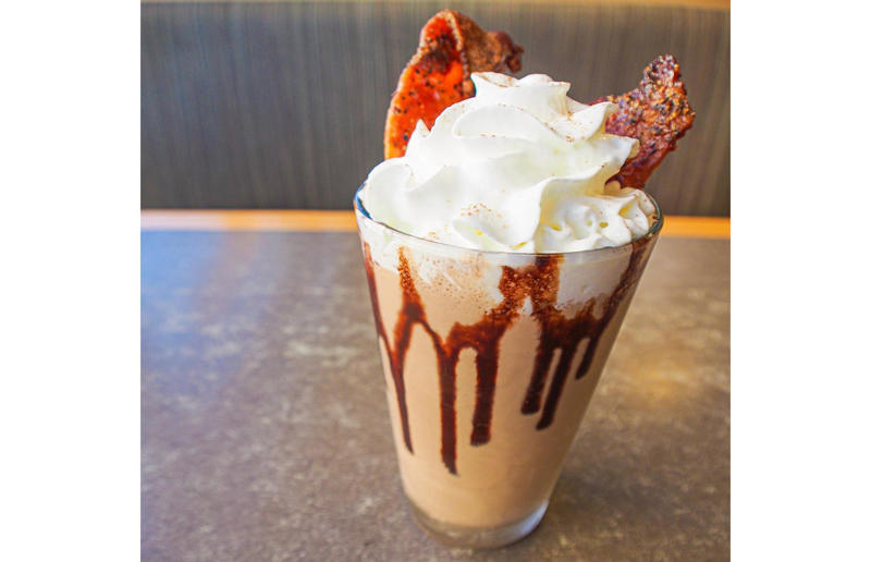 Alaska: Fat Elvis Milkshake, Snow City Cafe, Anchorage Bacon with EVERYTHING, Alabama: BALT, Urban Cookhouse, various locations, Alaska: Fat Elvis milkshake, Snow City Cafe, Anchorage, Arizona: stuffed Medjool dates, J.T. Prime Kitchen & Cocktails, Yuma, Arkansas: Eggniter, Golden Kolache Bakery, Fayetteville, California: B’B’B’ Bacon, Slater's 50/50, various locations, Colorado: signature bacon flight, Bacon Social House, various locations, Connecticut: smoked mac & cheese, Pig Rig BBQ, Wallingford, Delaware: bacon cheese fries, m2o Burgers & Salads, Newark, District of Columbia: glazed bacon lollis, Founding Farmers, various locations, Florida: candied bacon maple ice cream, Ulele, Tampa, Georgia: BBQ bacon, Burger 21, Kennesaw and Buford, Hawaii: Fat Boy, Hank's Haute Dogs, Honolulu, Idaho: bacon, egg, and cheese breakfast tacos, Tin Roof Tacos, various locations, Illinois: cheeseburger, Au Cheval, Chicago, Indiana: BLT croissant, Rize, various locations, Iowa: pancake sandwich, The Breakfast Club, various locations, Kansas: bleu cheese and bacon burger, The Anchor, Wichita, Kentucky: maple bacon donut, Nord's Bakery, Louisville, Louisiana: Buckboard Bacon Melt, Cochon Butcher, New Orleans, Maine: bacon Cheddar, The Holy Donut, Portland, Maryland: Baltimore Burger, Abbey Burger Bistro, Baltimore and Havre de Grace, Massachusetts: 'Irish' nachos, Harry's Bar & Grill, Boston, Michigan: BLT, Tony’s I-75, Birch Run, Minnesota: Millionaire bacon burger, Granite City Food & Brewery, various locations, Mississippi: Redneck Benny, Big Bad Breakfast, Oxford, Missouri: The Combo, Songbird, St. Louis, Montana: The 'Mazatlan' Mexican Dog, The Burger Dive, Billings, Nebraska: Greatest Burger Ever, Honest Abe’s Burgers & Freedom, Lincoln, Nebraska, Nevada: 24K Burger, Slater's 50/50, Las Vegas, New Hampshire: Bacon Bene, The Bacon Barn, Londonderry, New Jersey: bacon brisket sandwich, Bake'n Bacon, Cape May, New Mexico: BB&C, Urban Hotdog Company, Albuquerque, New York: Clothesline Bacon, David Burke Tavern, New York City, North Carolina: BLT, Merritt's Grill, Chapel Hill, North Dakota: The Elvis, Bearscat Bakehouse, Bismarck and Minot, Ohio: Biscuit BLT, Dough Mama, Columbus, Oklahoma: Brussels sprouts, Packard’s, Oklahoma City, Oregon: praline bacon, Screen Door, Portland, Pennsylvania: bacon flight, Bacon, Bourbon & Beer, Washington, Rhode Island: BLT, The Malted Barley, Providence, South Carolina: candied bacon brownie, Nose Dive, Greenville, South Dakota: bacon wrapped filet mignon, Alpine Inn, Hill City, Tennessee: Southern Sampler Breakfast, The Loveless Cafe, Nashville, Texas: chicken fried bacon, Sodolak's Original Country Inn, Snook, Utah: roasted bacon wrapped dates, Midway Mercantile Restaurant, Midway, Vermont: Breakfast Mac, Our House Bistro, Winooski, Virginia: Mother Clucker, Capitol Waffle Shop, various locations, Washington: Meatza, Windy City Pie, Seattle, West Virginia: hot chicken sandwich with bacon, Wood Iron Eatery, Fayetteville, Wisconsin: tequila jam burger, 11:11 Burgers & Beignets, Fond Du Lac, Wisconsin