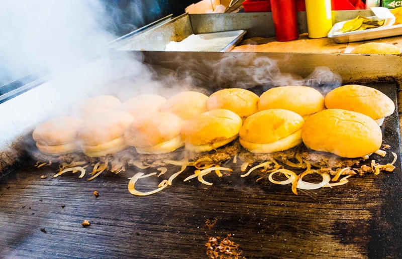 18. Michigan: sliders, Motz’s Burgers, Detroit 54. Tennessee: Dyer's Single, Dyer's Burgers, Memphis, 53. Alabama: hamburger, Dub's Burgers, Athens, 52. Connecticut: The Original Burger, Louis' Lunch, New Haven, 51. California: Steakburger, The Apple Pan, Los Angeles, 50. Iowa: hamburger, B-Bops, various locations, 49. Maine: hamburger, Black Cow, Portland, 48. New Jersey: hamburger, White Manna, Hackensack, 47. New Hampshire: hamburger, Gilley’s Diner, Portsmouth, 46. Massachusetts: Hamburg, White Hut, West Springfield, 45. California: hamburger, In-N-Out Burger, various locations, 44. District of Columbia: Farmhouse Burger, Good Stuff Eatery, Georgetown, 43. Mississippi: Slugburger, Latham's Hamburger Inn, New Albany, 42. Utah: Big Ben, Burger Bar, Roy, 41. Wisconsin: hamburger, Sobelman's Pub & Grill, Milwaukee, 40. Wyoming: The Liberty Burger, Liberty Burger, Jackson, 39. Illinois: House-blend prime beef burger, Butcher & The Burger, Chicago, 38. Arizona: The Standard at The Stand Arcadia Burger Shoppe, Phoenix, 37. Colorado: Cricket Burger, The Cherry Cricket, Denver, 36. New York: Luger burger, Peter Luger Steakhouse, New York City, 35. Delaware: FTC, Farmer & the Cow, Wilmington, 34. Minnesota: Jucy Lucy, Matt’s Bar, Minneapolis, 33. Pennsylvania: hamburger, M2O Burgers & Salads, Philadelphia, 32. South Carolina: Classic, Big Gun Burger Shop, Charleston, 31. Idaho: The Classic, Holy Cow!, Nampa, 30. Kansas: House Burger, Dempsey's Burger Pub, Wichita, 29. Missouri: hamburger, Town Topic, Kansas City, 28. Nebraska: The Original, Cheeseburgers, Omaha, 27. New Mexico: Rustic, Rustic On The Green, Albuquerque, 26. Indiana: Smash burger, Workingman’s Friend, Indianapolis, 25. Vermont: Worthy Burger, Worthy Burger, South Royalton and Woodstock, 24. Arkansas: traditional hamburger, Hugo's, Fayetteville, 23. Texas: Tookie's Burger, Tookie's Hamburgers & More, Kemah, 22. Nevada: Plain Jane, Beefy's, Reno, 21. Georgia: Green Truck Classic, Green Truck Pub, Savannah, 20. New York: hamburger, All-American Hamburger Drive-In, Massapequa, 19. North Dakota: Carport, Sickies Garage Burgers & Brews, various locations, 18. Michigan: sliders, Motz’s Burgers, Detroit, 17. Michigan: Ground Round, Miller’s Bar, Dearborn, 16. Florida: hamburger, Mac's Drive-Thru, Gainesville, 15. West Virginia: Oscar, Oscar’s Breakfast, Burgers & Brews, Barboursville, 14. North Carolina: hamburger, Brooks’ Sandwich House, Charlotte, 13. Kentucky: The Purist, Bard's Burgers & Chili, Covington, 12. Maryland: Hamburger, Burger Bros., Towson, 11. Oklahoma: single onion burger, Tucker's Onion Burgers, various locations, 10. Rhode Island: Stanley Burger, Stanley’s Famous Hamburgers, Central Falls, 9. Virginia: Beauvine, Beauvine Burger Concept, Richmond, 8. Oregon: The Original 100, Hwy 101 Burger, Lincoln City, 7. Ohio: hamburger, Kewpee Hamburgers, Lima, 6. Hawaii: hamburger, Kua Aina Sandwich Shop, Haleiwa, 5. Alaska: The Burger Stop, Tommy's Burger Stop, Anchorage, 4. Montana: Hamburger, The Burger Drive, Billings, 3. Washington: Seattle Classic, Von's 1000 Spirits, Seattle, 2. Louisiana: Butcher Burger, Cochon Butcher, New Orleans