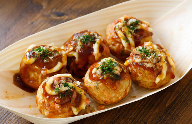 24. Takoyaki, Japan 37: Baklava, various locations, 36: Rolex, Uganda, 35: Dadar gulung, Indonesia, 34: Ta'ameya, Egypt, 33: Brownies, USA, 32: Plantain chips, various locations, 31: Koeksister, South Africa, 30: Ma'amoul, Egypt, 29: Takoyaki, Japan, 28: Rice Krispie treats, USA, 27: Poffertjes, Netherlands, 26: Haggis bon bons, Scotland, 25: Pão de queijo, Brazil, 24: Chocolate digestives, UK, 23: Churros, Spain, 22: Kartoffelpuffer, Germany, 21: Stroopwafel, Netherlands, 20: Mooncake, China, 19: Sausage roll, UK, 18: Biltong, South Africa, 17: Aloo tikki, India, 16: Qatayef, Middle East, 15: Lamington, Australia, 14: S'mores, USA, 13: Meat pie, Australia and New Zealand, 12: Lumpia, Indonesia and the Philippines, 11: Nanaimo bar, Canada, 10: Pain au chocolat, France, 9: Mochi, Japan, 8: Pani puri, India, 7: Doughnut, various locations, 6: Poutine, Canada, 5: Currywurst, Germany, 4: Macaron, France, 3: Nachos, Mexico, 2: Samosa, various locations