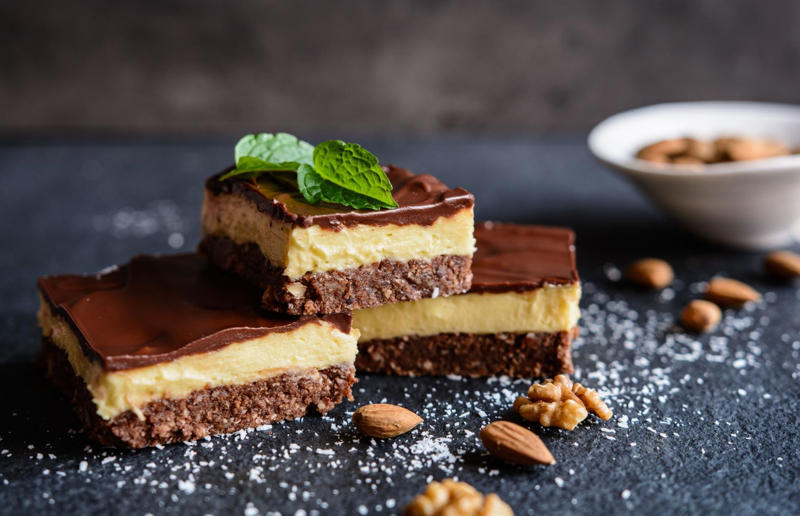 9. Nanaimo bar, Canada 37: Baklava, various locations, 36: Rolex, Uganda, 35: Dadar gulung, Indonesia, 34: Ta'ameya, Egypt, 33: Brownies, USA, 32: Plantain chips, various locations, 31: Koeksister, South Africa, 30: Ma'amoul, Egypt, 29: Takoyaki, Japan, 28: Rice Krispie treats, USA, 27: Poffertjes, Netherlands, 26: Haggis bon bons, Scotland, 25: Pão de queijo, Brazil, 24: Chocolate digestives, UK, 23: Churros, Spain, 22: Kartoffelpuffer, Germany, 21: Stroopwafel, Netherlands, 20: Mooncake, China, 19: Sausage roll, UK, 18: Biltong, South Africa, 17: Aloo tikki, India, 16: Qatayef, Middle East, 15: Lamington, Australia, 14: S'mores, USA, 13: Meat pie, Australia and New Zealand, 12: Lumpia, Indonesia and the Philippines, 11: Nanaimo bar, Canada, 10: Pain au chocolat, France, 9: Mochi, Japan, 8: Pani puri, India, 7: Doughnut, various locations, 6: Poutine, Canada, 5: Currywurst, Germany, 4: Macaron, France, 3: Nachos, Mexico, 2: Samosa, various locations