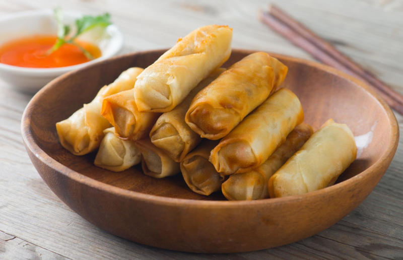 10. Lumpia, Indonesia and the Philippines 37: Baklava, various locations, 36: Rolex, Uganda, 35: Dadar gulung, Indonesia, 34: Ta'ameya, Egypt, 33: Brownies, USA, 32: Plantain chips, various locations, 31: Koeksister, South Africa, 30: Ma'amoul, Egypt, 29: Takoyaki, Japan, 28: Rice Krispie treats, USA, 27: Poffertjes, Netherlands, 26: Haggis bon bons, Scotland, 25: Pão de queijo, Brazil, 24: Chocolate digestives, UK, 23: Churros, Spain, 22: Kartoffelpuffer, Germany, 21: Stroopwafel, Netherlands, 20: Mooncake, China, 19: Sausage roll, UK, 18: Biltong, South Africa, 17: Aloo tikki, India, 16: Qatayef, Middle East, 15: Lamington, Australia, 14: S'mores, USA, 13: Meat pie, Australia and New Zealand, 12: Lumpia, Indonesia and the Philippines, 11: Nanaimo bar, Canada, 10: Pain au chocolat, France, 9: Mochi, Japan, 8: Pani puri, India, 7: Doughnut, various locations, 6: Poutine, Canada, 5: Currywurst, Germany, 4: Macaron, France, 3: Nachos, Mexico, 2: Samosa, various locations