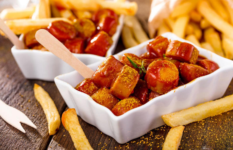 4. Currywurst, Germany 37: Baklava, various locations, 36: Rolex, Uganda, 35: Dadar gulung, Indonesia, 34: Ta'ameya, Egypt, 33: Brownies, USA, 32: Plantain chips, various locations, 31: Koeksister, South Africa, 30: Ma'amoul, Egypt, 29: Takoyaki, Japan, 28: Rice Krispie treats, USA, 27: Poffertjes, Netherlands, 26: Haggis bon bons, Scotland, 25: Pão de queijo, Brazil, 24: Chocolate digestives, UK, 23: Churros, Spain, 22: Kartoffelpuffer, Germany, 21: Stroopwafel, Netherlands, 20: Mooncake, China, 19: Sausage roll, UK, 18: Biltong, South Africa, 17: Aloo tikki, India, 16: Qatayef, Middle East, 15: Lamington, Australia, 14: S'mores, USA, 13: Meat pie, Australia and New Zealand, 12: Lumpia, Indonesia and the Philippines, 11: Nanaimo bar, Canada, 10: Pain au chocolat, France, 9: Mochi, Japan, 8: Pani puri, India, 7: Doughnut, various locations, 6: Poutine, Canada, 5: Currywurst, Germany, 4: Macaron, France, 3: Nachos, Mexico, 2: Samosa, various locations