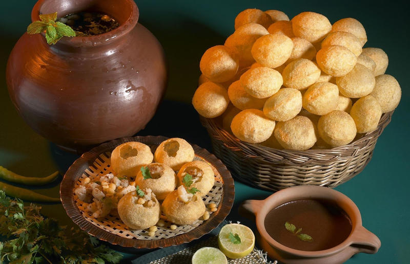 7. Pani puri, India 37: Baklava, various locations, 36: Rolex, Uganda, 35: Dadar gulung, Indonesia, 34: Ta'ameya, Egypt, 33: Brownies, USA, 32: Plantain chips, various locations, 31: Koeksister, South Africa, 30: Ma'amoul, Egypt, 29: Takoyaki, Japan, 28: Rice Krispie treats, USA, 27: Poffertjes, Netherlands, 26: Haggis bon bons, Scotland, 25: Pão de queijo, Brazil, 24: Chocolate digestives, UK, 23: Churros, Spain, 22: Kartoffelpuffer, Germany, 21: Stroopwafel, Netherlands, 20: Mooncake, China, 19: Sausage roll, UK, 18: Biltong, South Africa, 17: Aloo tikki, India, 16: Qatayef, Middle East, 15: Lamington, Australia, 14: S'mores, USA, 13: Meat pie, Australia and New Zealand, 12: Lumpia, Indonesia and the Philippines, 11: Nanaimo bar, Canada, 10: Pain au chocolat, France, 9: Mochi, Japan, 8: Pani puri, India, 7: Doughnut, various locations, 6: Poutine, Canada, 5: Currywurst, Germany, 4: Macaron, France, 3: Nachos, Mexico, 2: Samosa, various locations