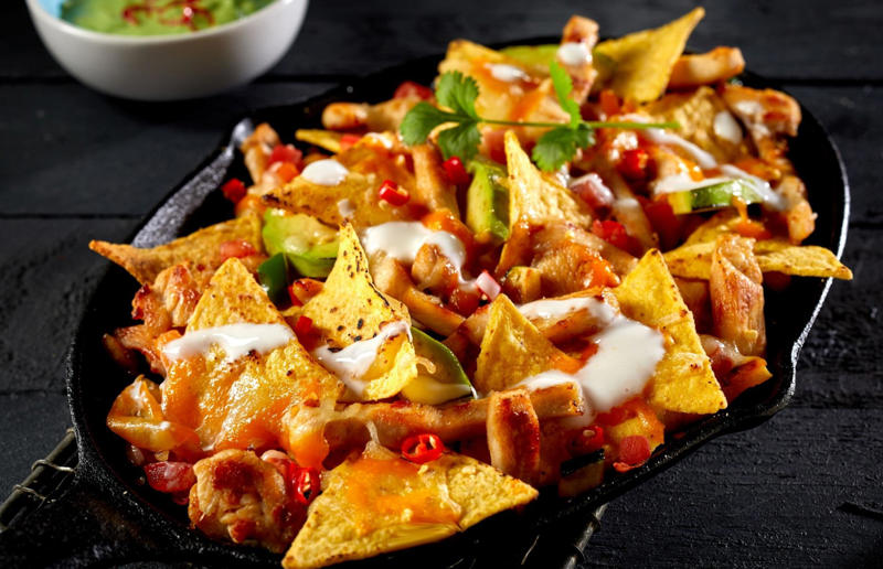 3. Nachos, Mexico 37: Baklava, various locations, 36: Rolex, Uganda, 35: Dadar gulung, Indonesia, 34: Ta'ameya, Egypt, 33: Brownies, USA, 32: Plantain chips, various locations, 31: Koeksister, South Africa, 30: Ma'amoul, Egypt, 29: Takoyaki, Japan, 28: Rice Krispie treats, USA, 27: Poffertjes, Netherlands, 26: Haggis bon bons, Scotland, 25: Pão de queijo, Brazil, 24: Chocolate digestives, UK, 23: Churros, Spain, 22: Kartoffelpuffer, Germany, 21: Stroopwafel, Netherlands, 20: Mooncake, China, 19: Sausage roll, UK, 18: Biltong, South Africa, 17: Aloo tikki, India, 16: Qatayef, Middle East, 15: Lamington, Australia, 14: S'mores, USA, 13: Meat pie, Australia and New Zealand, 12: Lumpia, Indonesia and the Philippines, 11: Nanaimo bar, Canada, 10: Pain au chocolat, France, 9: Mochi, Japan, 8: Pani puri, India, 7: Doughnut, various locations, 6: Poutine, Canada, 5: Currywurst, Germany, 4: Macaron, France, 3: Nachos, Mexico, 2: Samosa, various locations