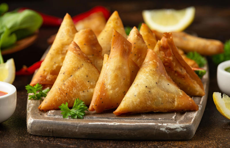 2. Samosa, various locations 37: Baklava, various locations, 36: Rolex, Uganda, 35: Dadar gulung, Indonesia, 34: Ta'ameya, Egypt, 33: Brownies, USA, 32: Plantain chips, various locations, 31: Koeksister, South Africa, 30: Ma'amoul, Egypt, 29: Takoyaki, Japan, 28: Rice Krispie treats, USA, 27: Poffertjes, Netherlands, 26: Haggis bon bons, Scotland, 25: Pão de queijo, Brazil, 24: Chocolate digestives, UK, 23: Churros, Spain, 22: Kartoffelpuffer, Germany, 21: Stroopwafel, Netherlands, 20: Mooncake, China, 19: Sausage roll, UK, 18: Biltong, South Africa, 17: Aloo tikki, India, 16: Qatayef, Middle East, 15: Lamington, Australia, 14: S'mores, USA, 13: Meat pie, Australia and New Zealand, 12: Lumpia, Indonesia and the Philippines, 11: Nanaimo bar, Canada, 10: Pain au chocolat, France, 9: Mochi, Japan, 8: Pani puri, India, 7: Doughnut, various locations, 6: Poutine, Canada, 5: Currywurst, Germany, 4: Macaron, France, 3: Nachos, Mexico, 2: Samosa, various locations