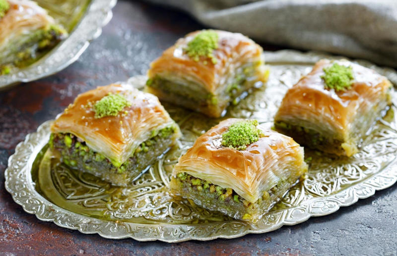 30. Baklava, various locations 37: Baklava, various locations, 36: Rolex, Uganda, 35: Dadar gulung, Indonesia, 34: Ta'ameya, Egypt, 33: Brownies, USA, 32: Plantain chips, various locations, 31: Koeksister, South Africa, 30: Ma'amoul, Egypt, 29: Takoyaki, Japan, 28: Rice Krispie treats, USA, 27: Poffertjes, Netherlands, 26: Haggis bon bons, Scotland, 25: Pão de queijo, Brazil, 24: Chocolate digestives, UK, 23: Churros, Spain, 22: Kartoffelpuffer, Germany, 21: Stroopwafel, Netherlands, 20: Mooncake, China, 19: Sausage roll, UK, 18: Biltong, South Africa, 17: Aloo tikki, India, 16: Qatayef, Middle East, 15: Lamington, Australia, 14: S'mores, USA, 13: Meat pie, Australia and New Zealand, 12: Lumpia, Indonesia and the Philippines, 11: Nanaimo bar, Canada, 10: Pain au chocolat, France, 9: Mochi, Japan, 8: Pani puri, India, 7: Doughnut, various locations, 6: Poutine, Canada, 5: Currywurst, Germany, 4: Macaron, France, 3: Nachos, Mexico, 2: Samosa, various locations