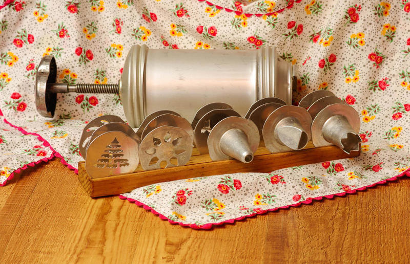 Retro kitchen items from way back when, Salad spinner, Butter curler, Flour shaker, Manual food mincer, Lattice pastry roller, Manual weighing scales, Fish kettle, Tea strainer, Egg slicer, Cookie press, Recipe card boxes, Butter dishes, Mesh food tents, Needlework art, Cut-glass punch bowls, Bread boxes, Tiered storage baskets, Decorative plates, Jelly moulds, Potato ricers, Sink skirts, Tea and coffee containers, Decorative placemats, Heavily patterned tiles, Condiment serving trays, Dried goods, Matching tea set, Manual hand mixers, Old cookbooks, Gravy boats, Novelty teapots, Novelty tea towels, Net curtains and skirts, Cake stands, Teapots and cosies, Manual egg timers, Pressure cookers, Egg separators, Ice crusher, Pyrex casserole dishes