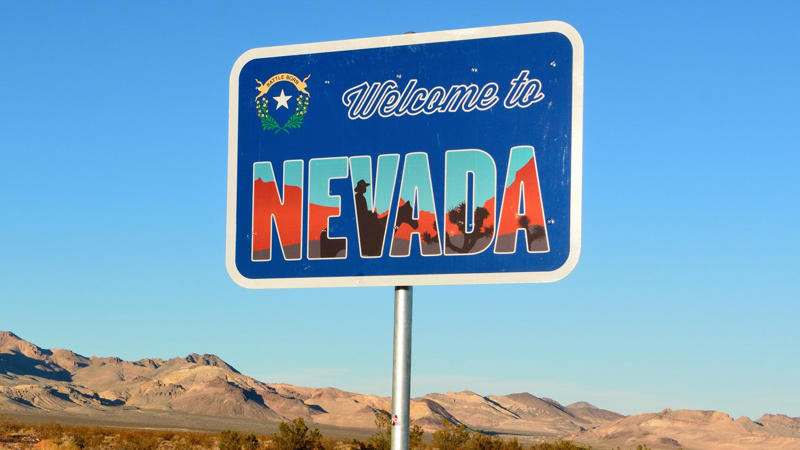 welcome to nevada road sign_iStock-900120318 Arkansas, California, Connecticut, Delaware, Illinois, Kentucky, Maryland, Massachusetts, Minnesota, Mississippi, Missouri, Nebraska, New Hampshire, New Mexico, New York, North Carolina, Oklahoma, Rhode Island, South Carolina, South Dakota, Washington, West Virginia, Wisconsin